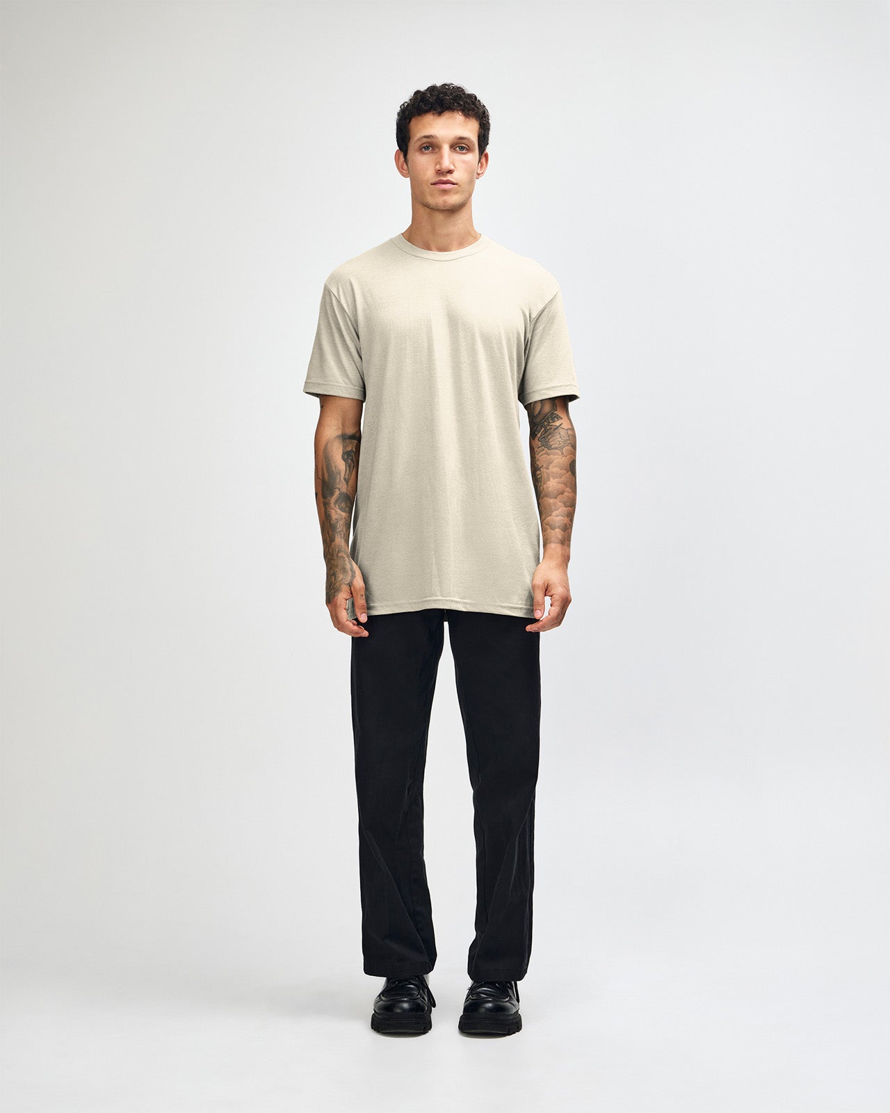 Male model wearing heather bone colour CVC Unisex Short Sleeve Crew Neck Tee (front pose) -heather bone