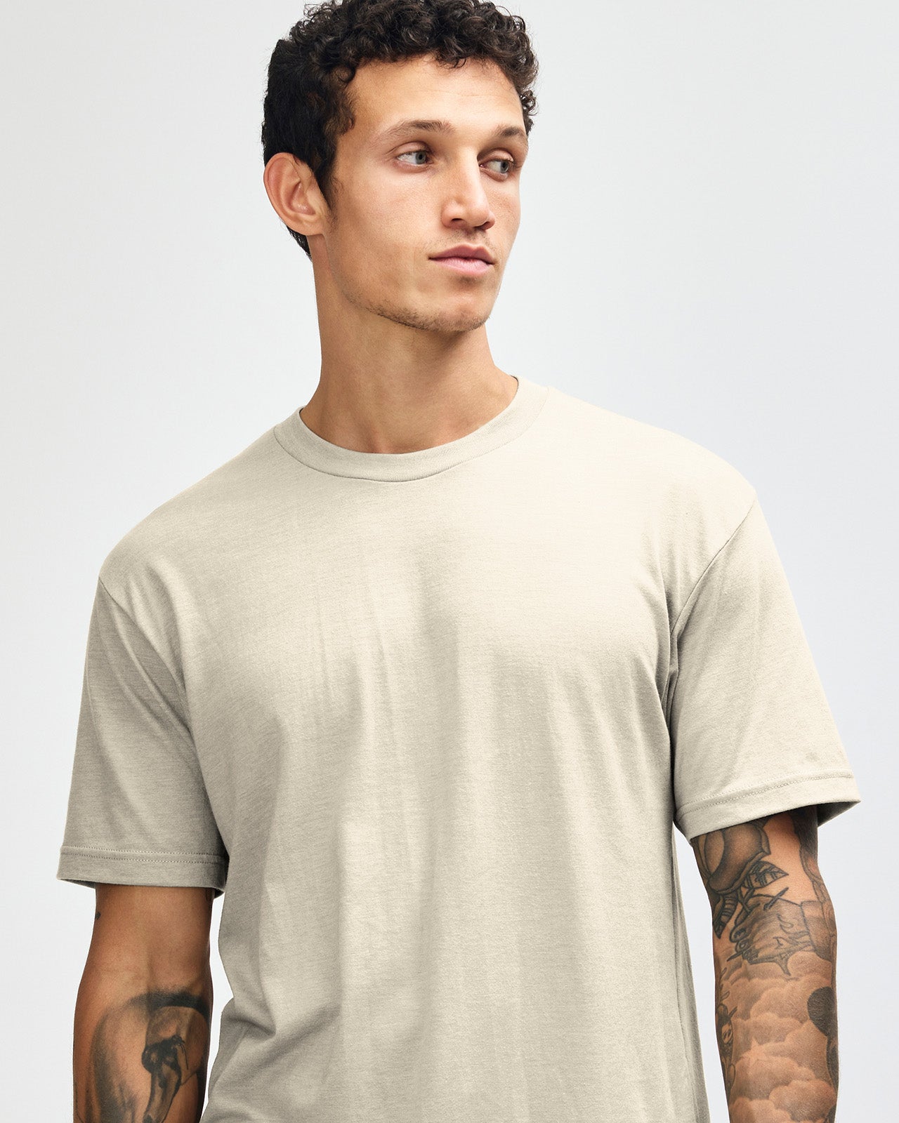 Male model wearing heather bone colour CVC Unisex Short Sleeve Crew Neck Tee (front pose) -heather bone