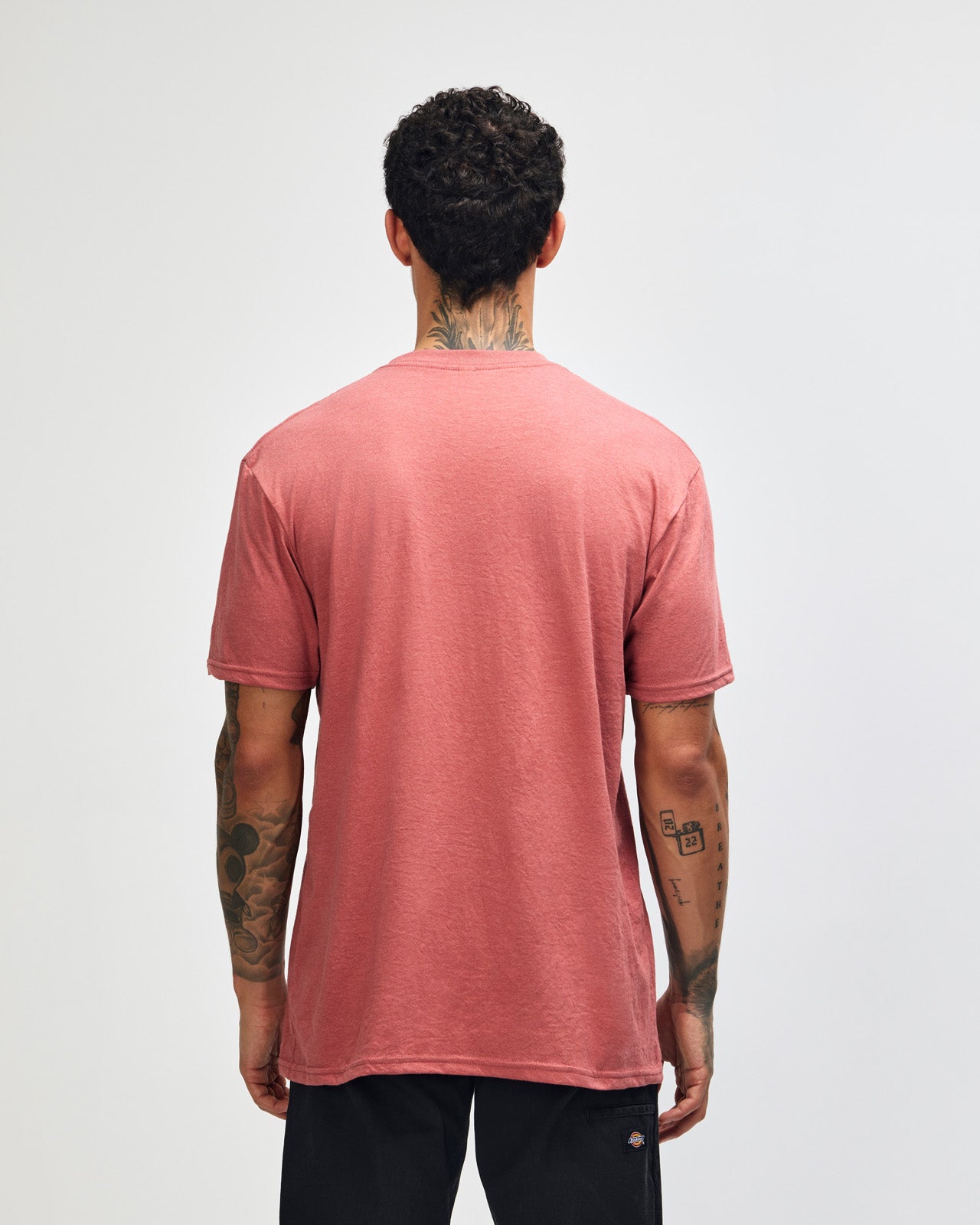 Male model wearing heather canyon colour CVC Unisex Short Sleeve Crew Neck Tee (back pose) -heather canyon