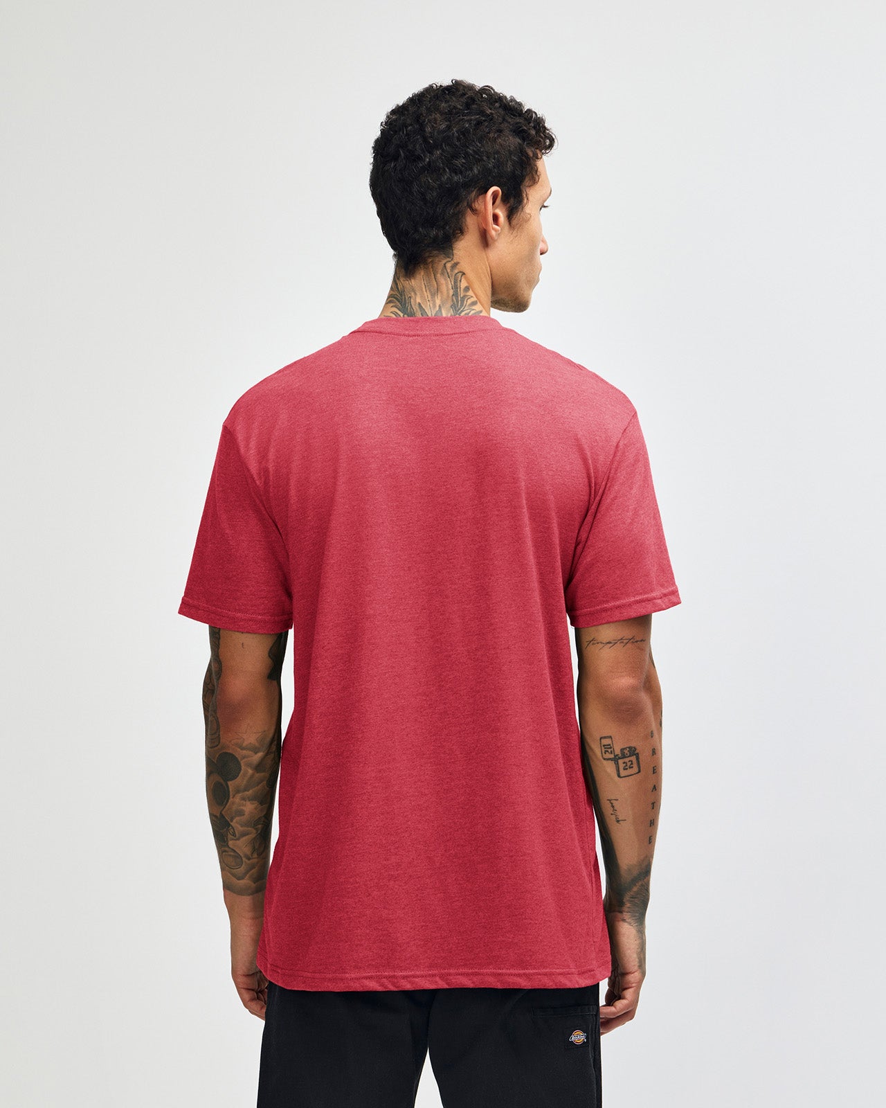 Male model wearing heather Cardinal colour CVC Unisex Short Sleeve Crew Neck Tee (back pose) -heather cardinal