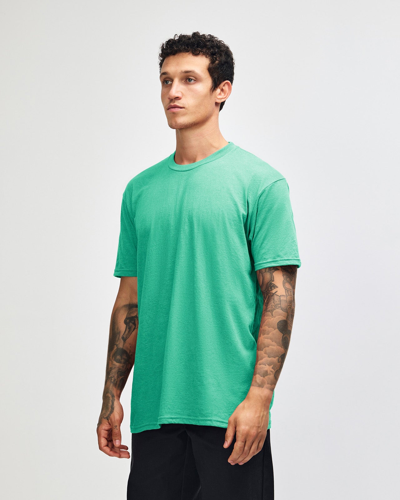Male model wearing heather celadon colour CVC Unisex Short Sleeve Crew Neck Tee (front pose) -heather celadon