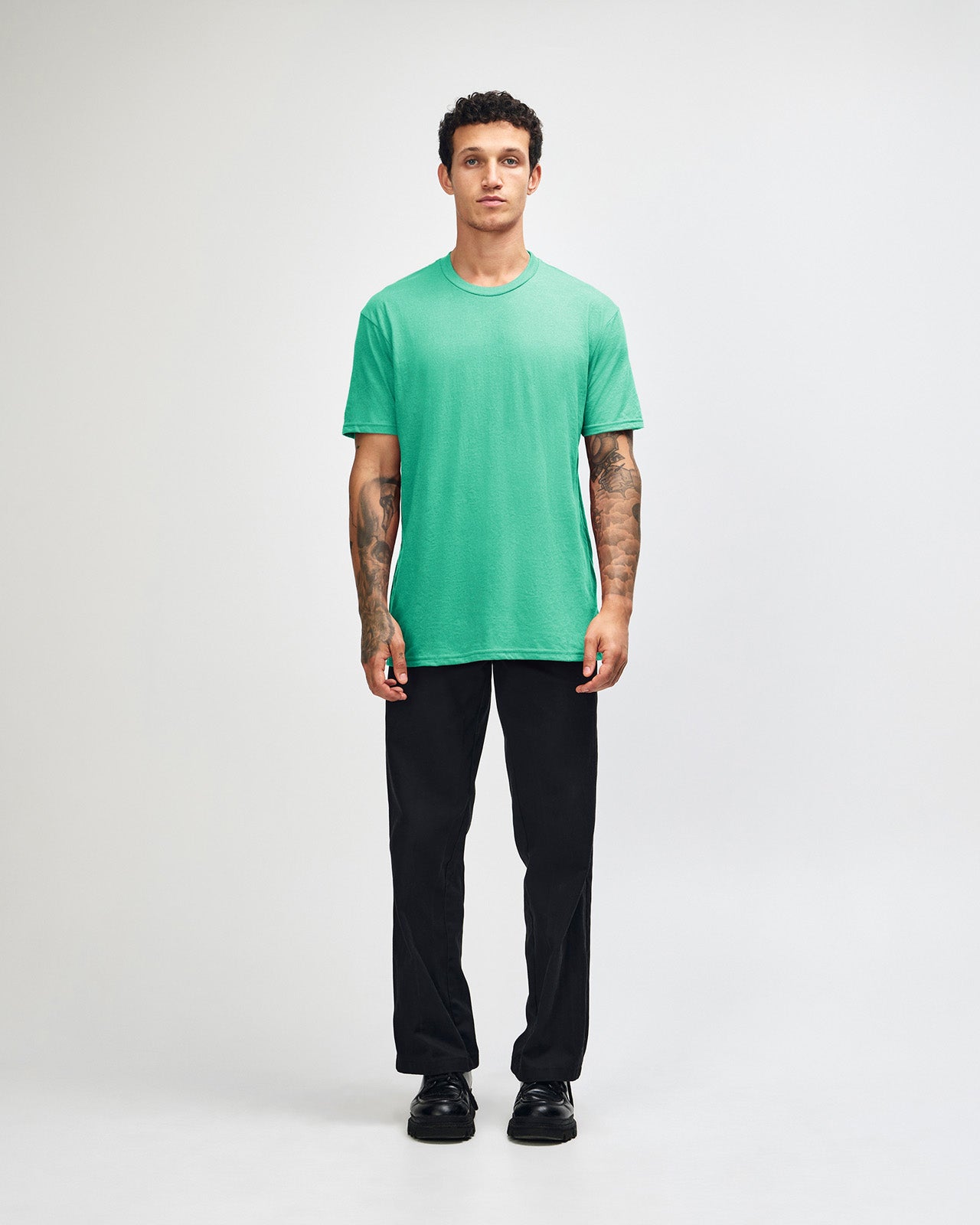 Male model wearing heather celadon colour CVC Unisex Short Sleeve Crew Neck Tee (front pose) -heather celadon