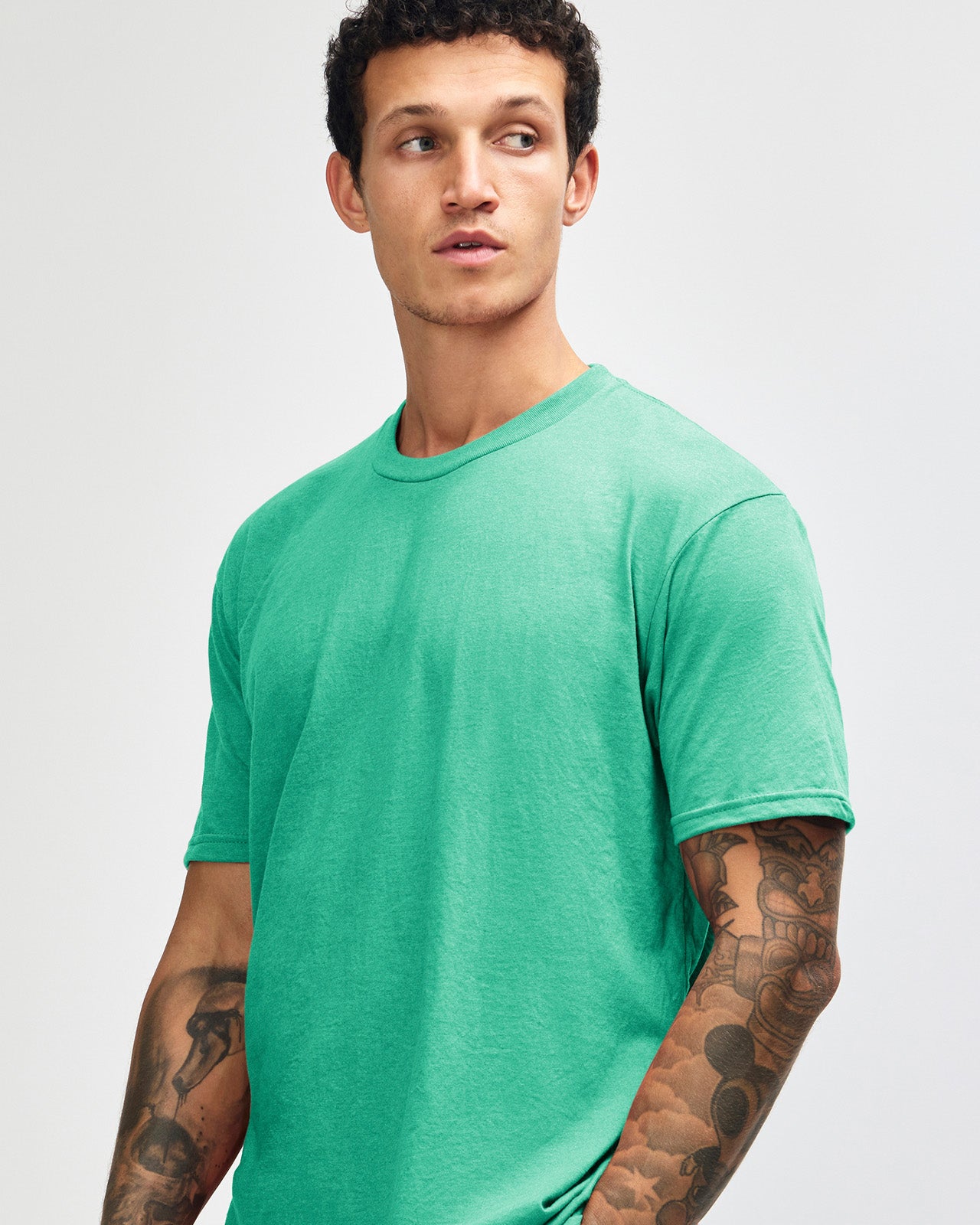Male model wearing heather celadon colour CVC Unisex Short Sleeve Crew Neck Tee (front pose) -heather celadon