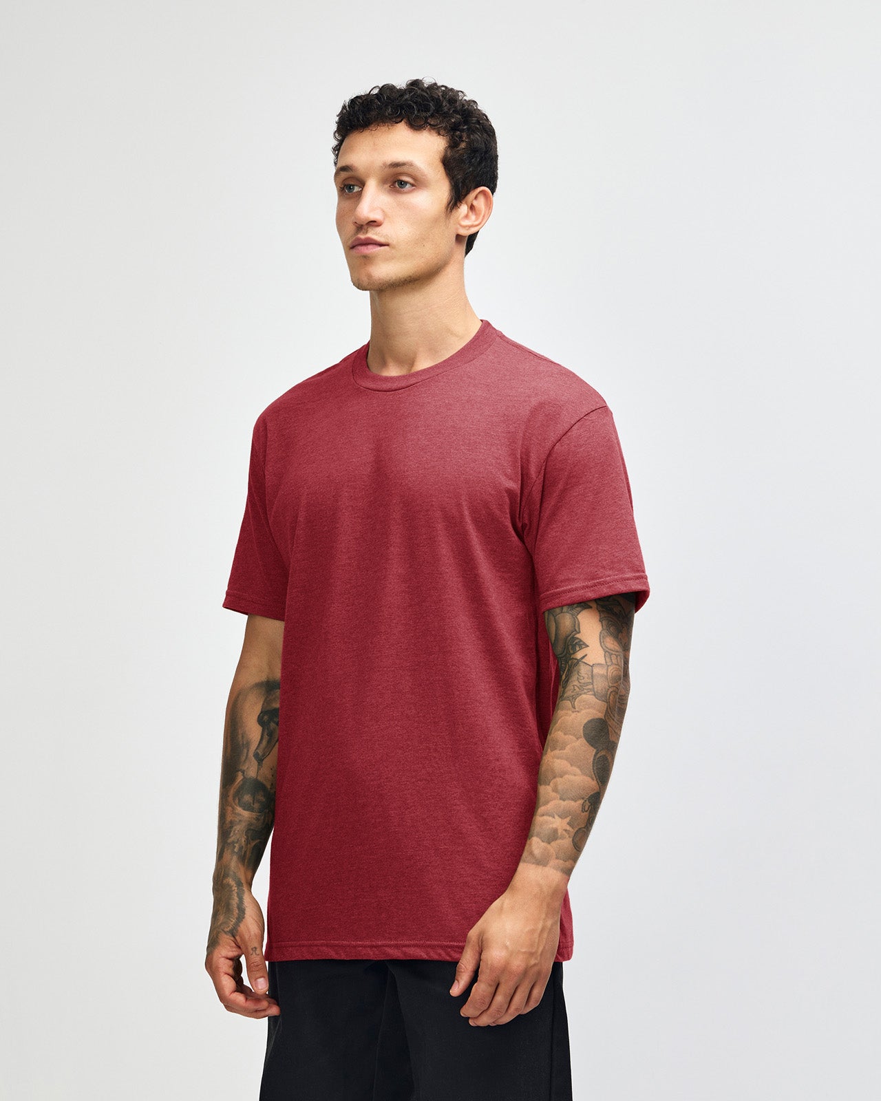 Male model wearing heather cranberry colour CVC Unisex Short Sleeve Crew Neck Tee (front pose) -heather cranberry