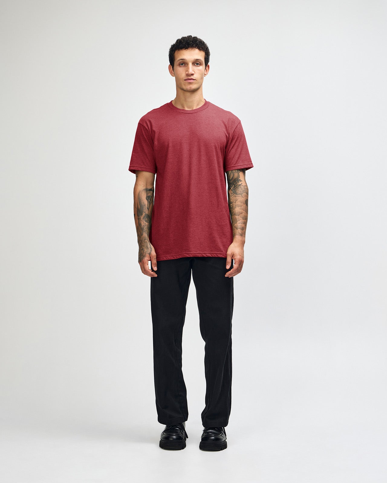 Male model wearing heather cranberry colour CVC Unisex Short Sleeve Crew Neck Tee (front pose) -heather cranberry