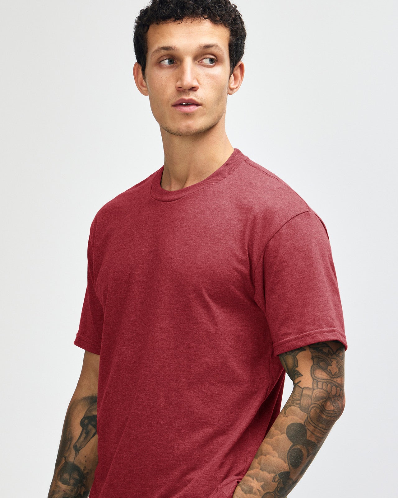 Male model wearing heather cranberry colour CVC Unisex Short Sleeve Crew Neck Tee (front pose) -heather cranberry