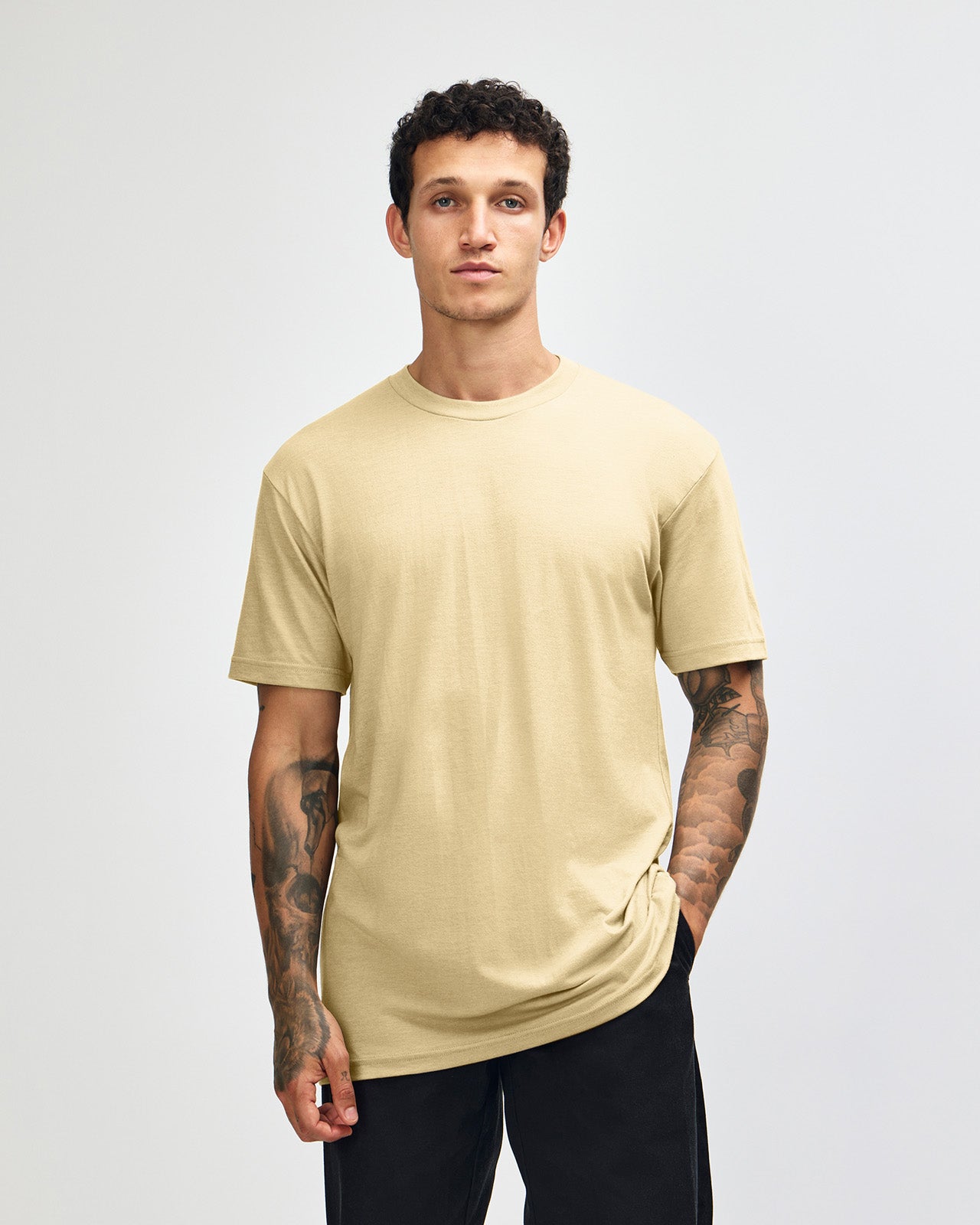 Male model wearing heather cream colour CVC Unisex Short Sleeve Crew Neck Tee (front pose) -heather cream