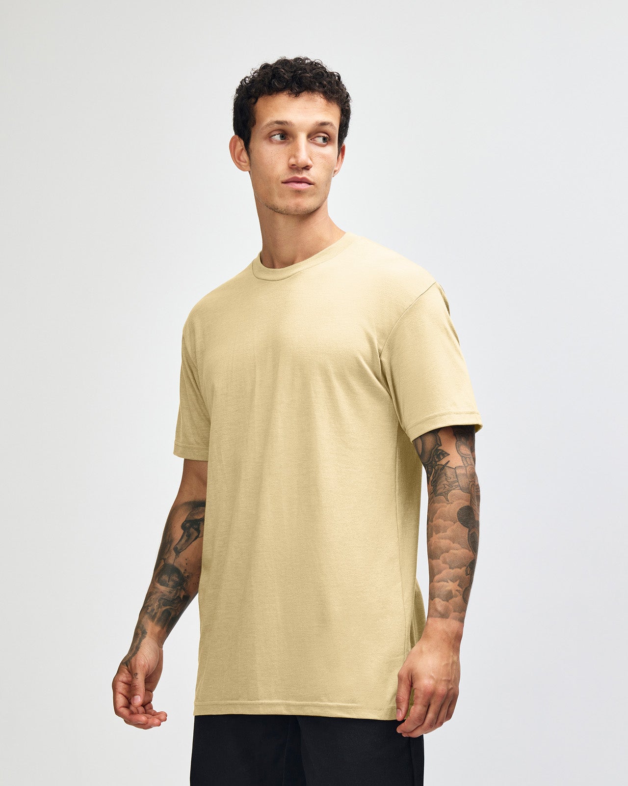 Male model wearing heather cream colour CVC Unisex Short Sleeve Crew Neck Tee (front pose) -heather cream