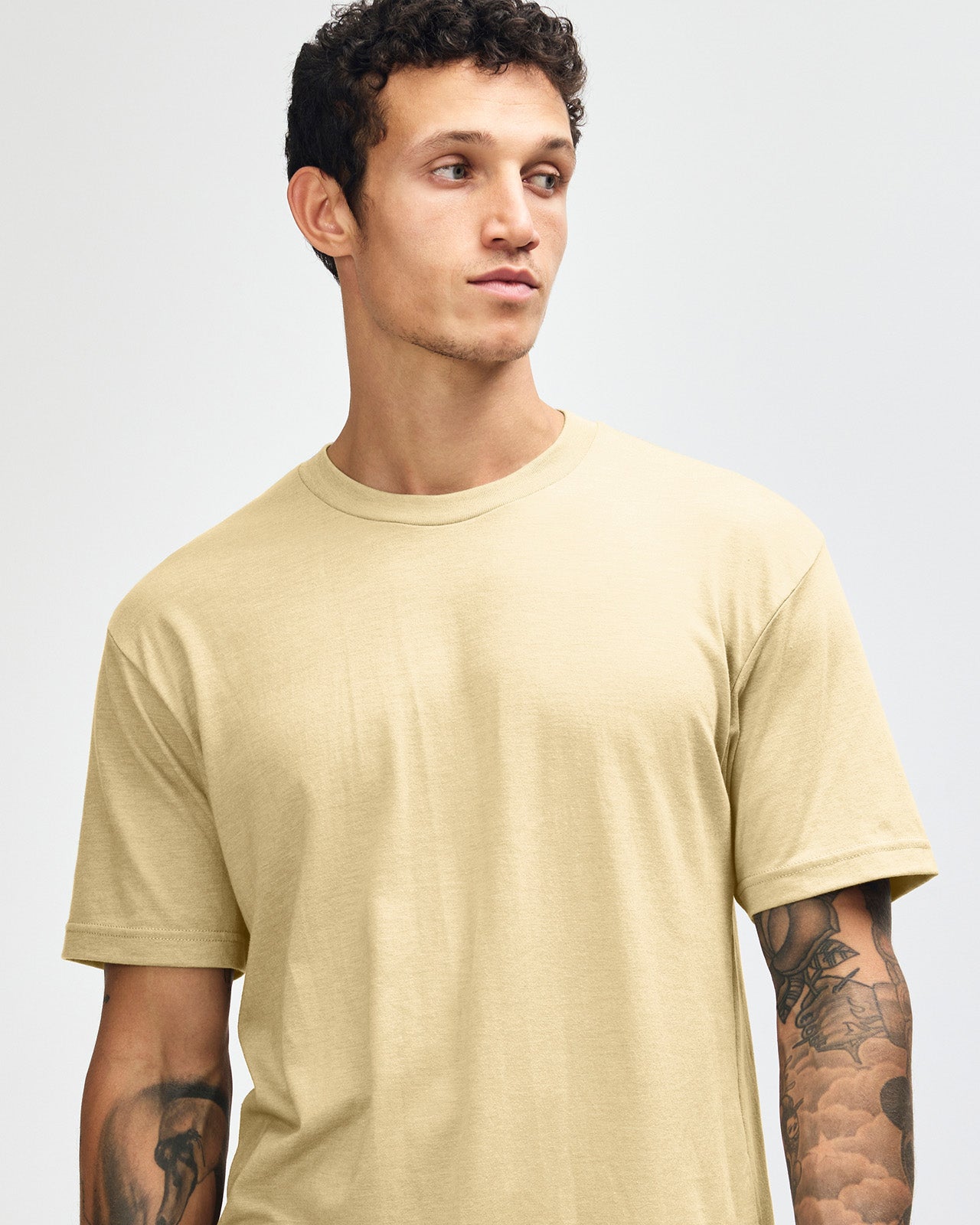 Male model wearing heather cream colour CVC Unisex Short Sleeve Crew Neck Tee (front pose) -heather cream