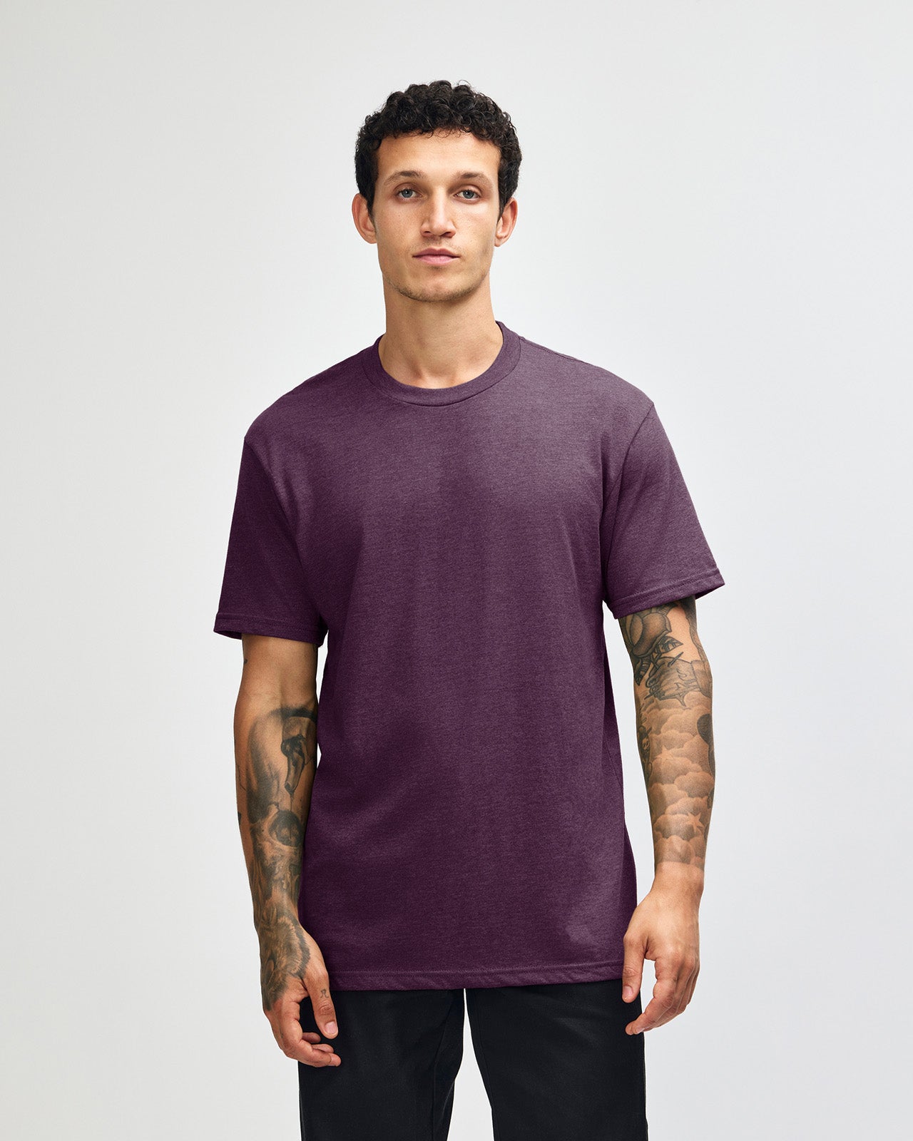 Male model wearing heather eggplant colour CVC Unisex Short Sleeve Crew Neck Tee (front pose) -heather eggplant