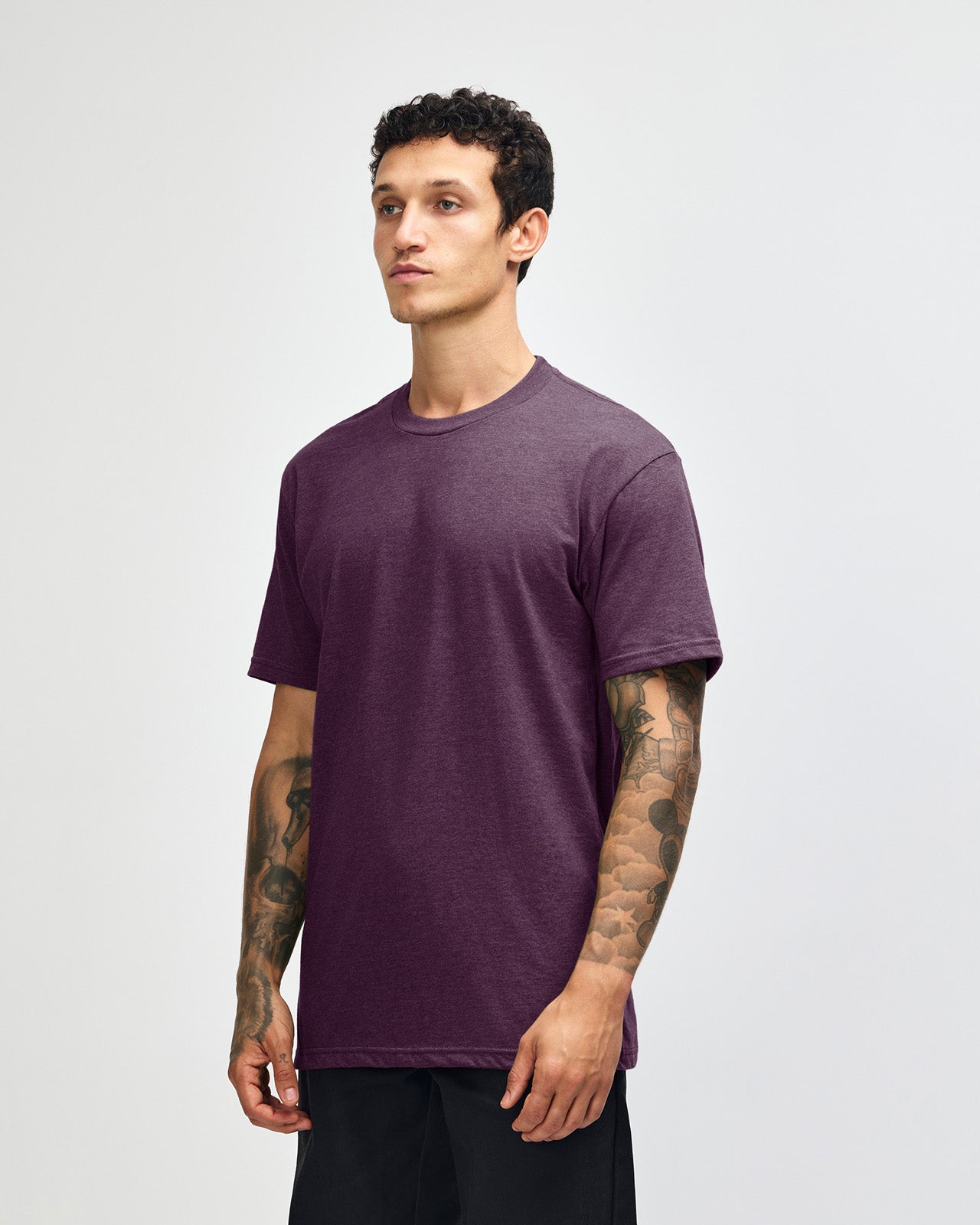 Male model wearing heather eggplant colour CVC Unisex Short Sleeve Crew Neck Tee (front pose) -heather eggplant