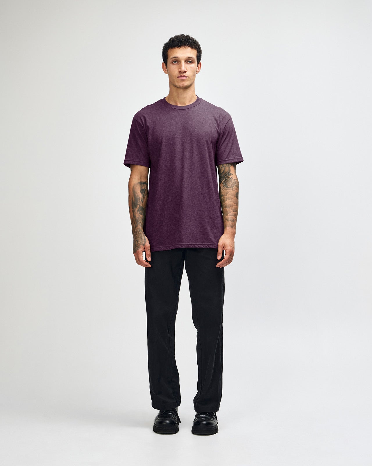 Male model wearing heather eggplant colour CVC Unisex Short Sleeve Crew Neck Tee (front pose) -heather eggplant