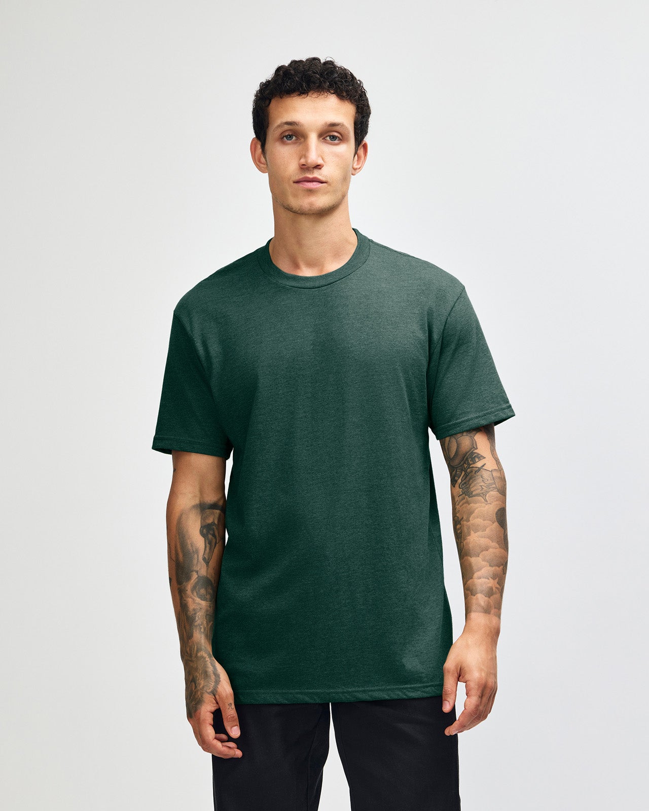 Male model wearing heather forest colour CVC Unisex Short Sleeve Crew Neck Tee (front pose) -heather forest