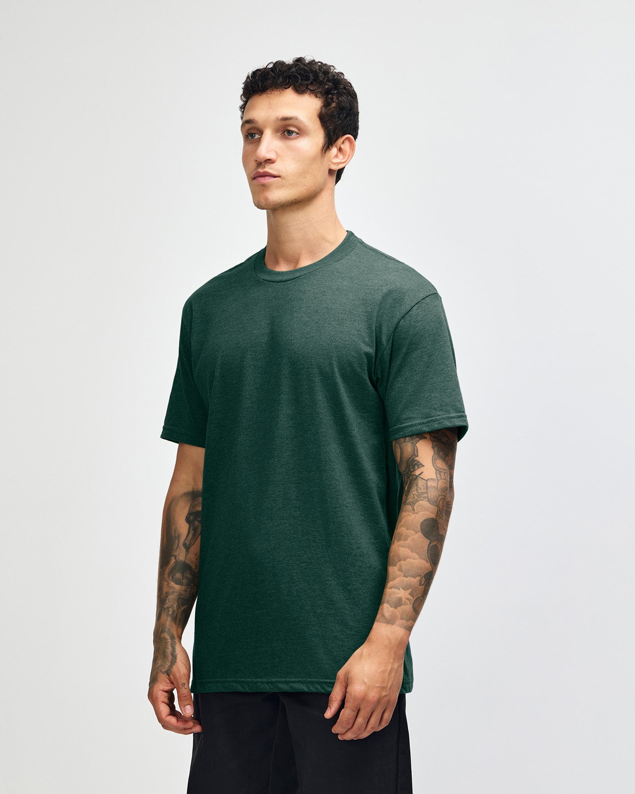 Male model wearing heather forest colour CVC Unisex Short Sleeve Crew Neck Tee (front pose) -heather forest