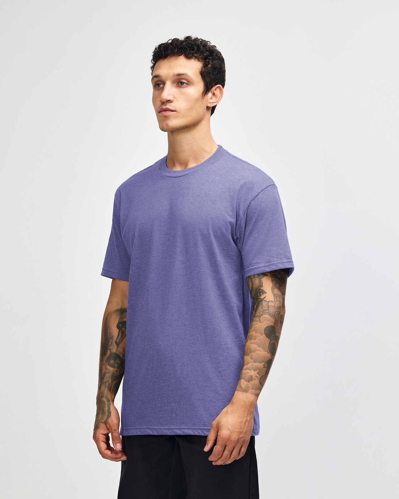 Male model wearing heather grape colour CVC Unisex Short Sleeve Crew Neck Tee (front pose) -heather grape