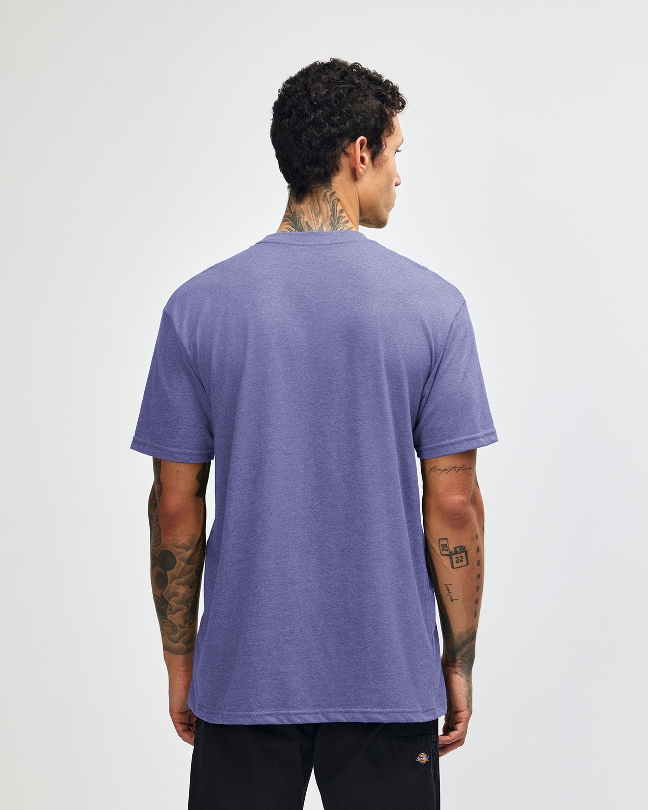 Male model wearing heather grape colour CVC Unisex Short Sleeve Crew Neck Tee (back pose) -heather grape