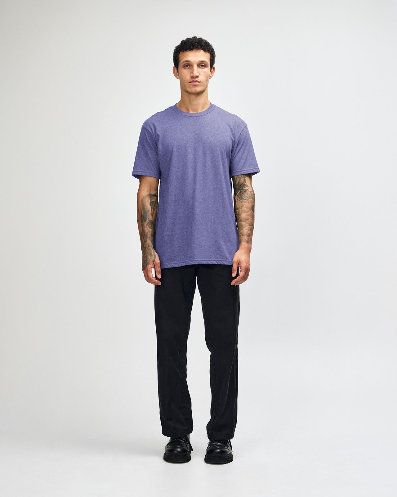 Male model wearing heather grape colour CVC Unisex Short Sleeve Crew Neck Tee (front pose) -heather grape