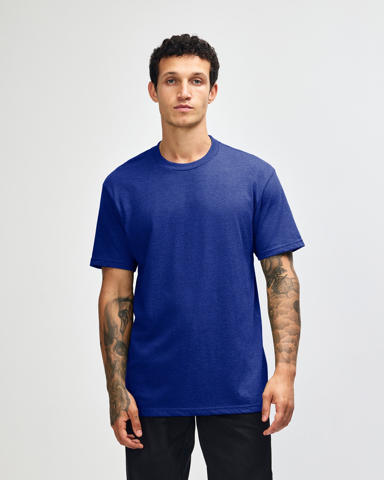 Male model wearing heather lapis colour CVC Unisex Short Sleeve Crew Neck Tee (front pose) -heather lapis