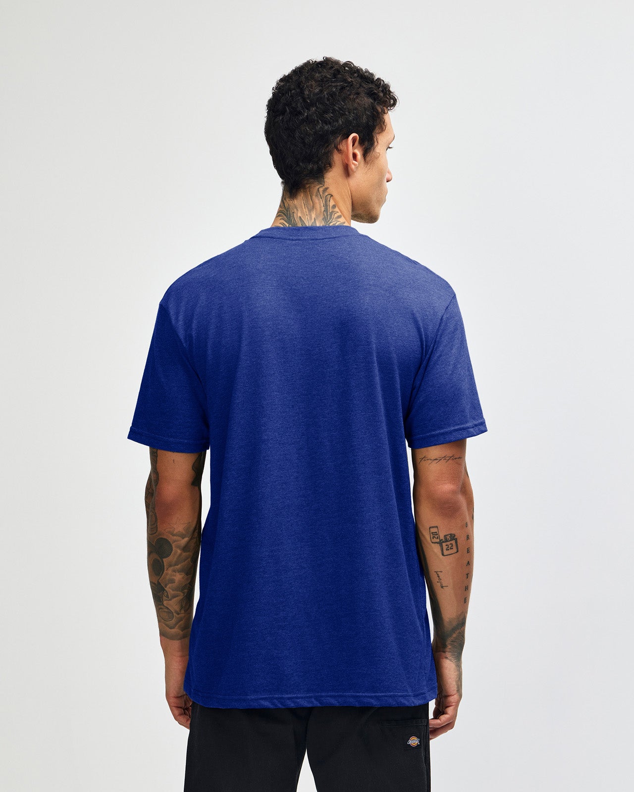Male model wearing heather lapis colour CVC Unisex Short Sleeve Crew Neck Tee (back pose) -heather lapis