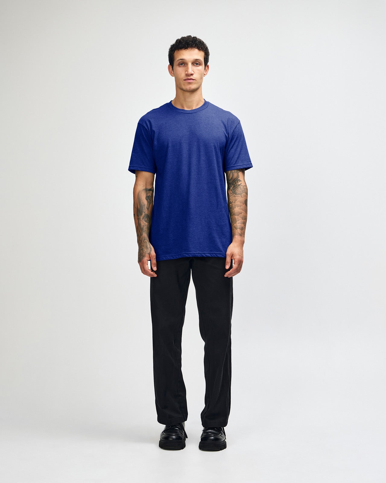 Male model wearing heather lapis colour CVC Unisex Short Sleeve Crew Neck Tee (front pose) -heather lapis
