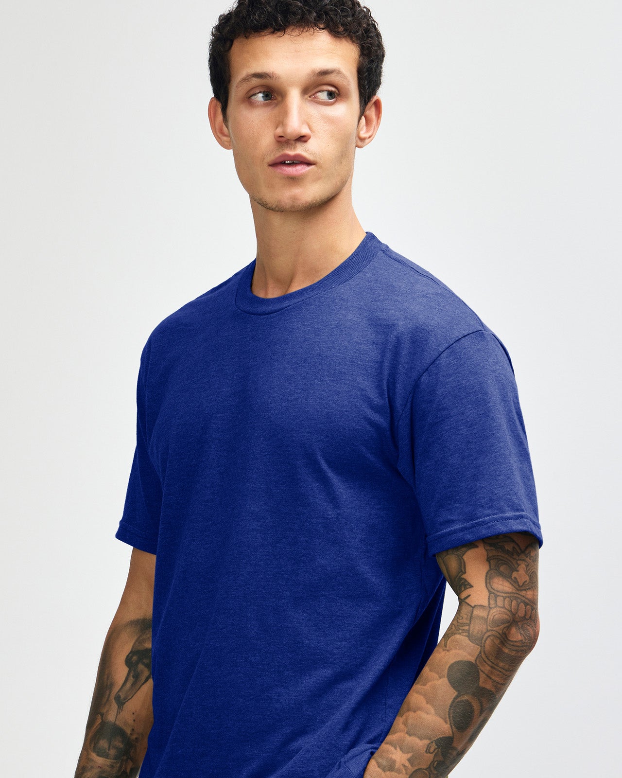 Male model wearing heather lapis colour CVC Unisex Short Sleeve Crew Neck Tee (front pose) -heather lapis