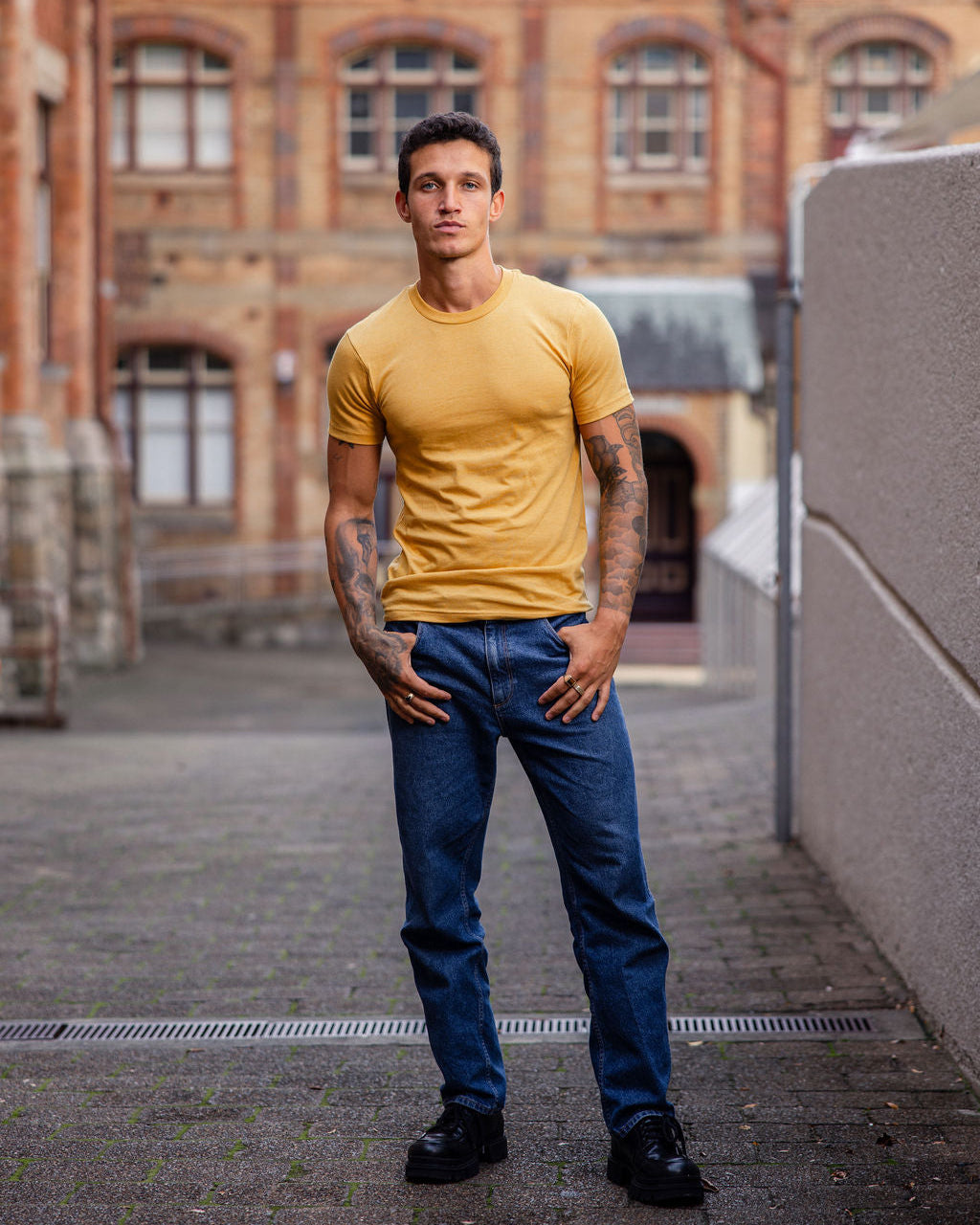 Male model wearing heather mustard colour CVC Unisex Short Sleeve Crew Neck Tee (front pose) -heather mustard