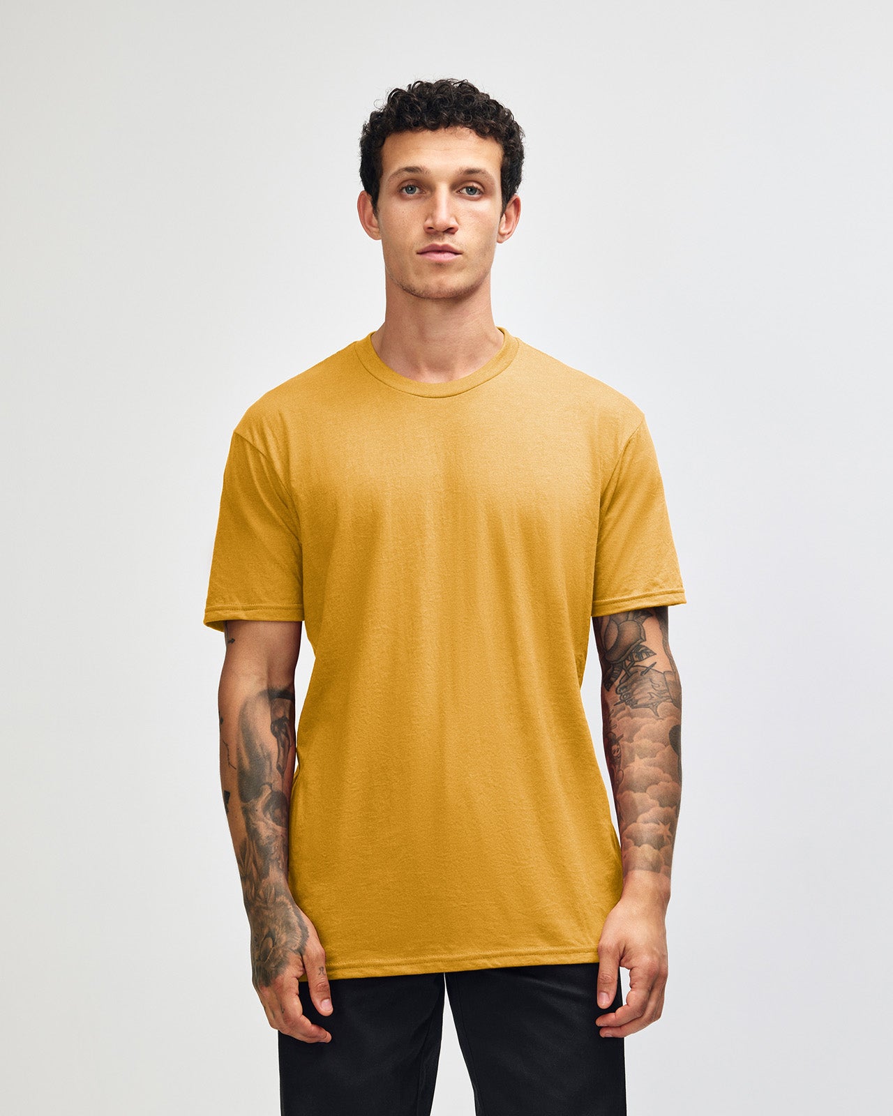 Male model wearing heather mustard colour CVC Unisex Short Sleeve Crew Neck Tee (front pose) -heather mustard