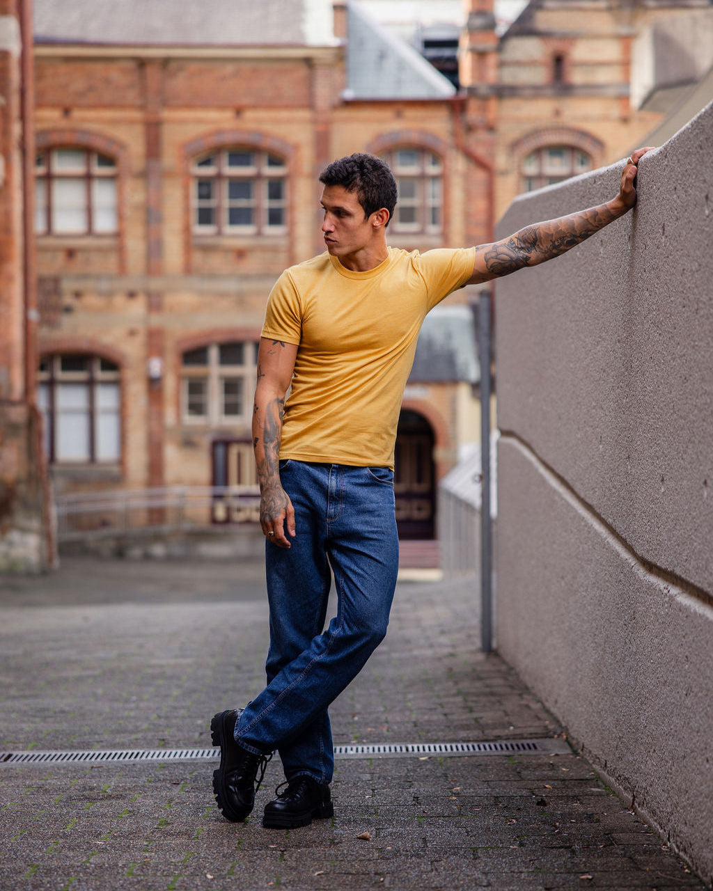 Male model wearing heather mustard colour CVC Unisex Short Sleeve Crew Neck Tee (front pose) -heather mustard