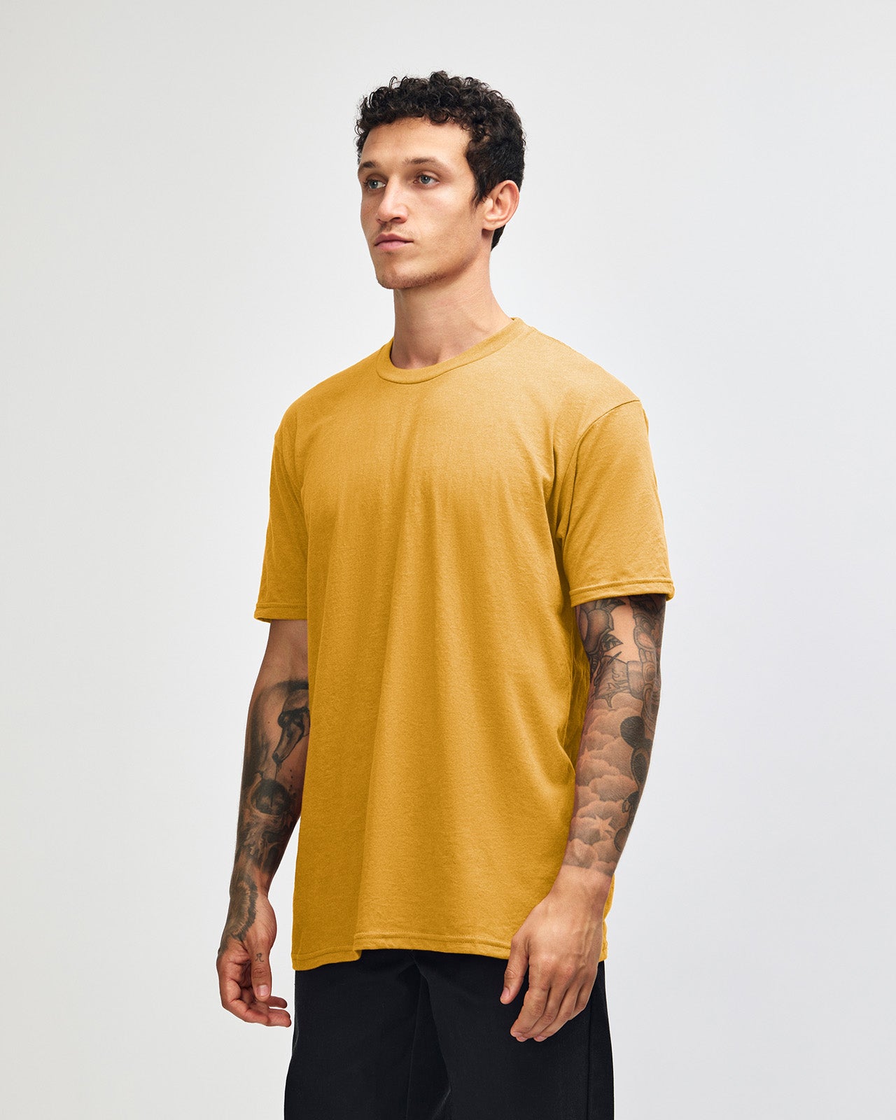 Male model wearing heather mustard colour CVC Unisex Short Sleeve Crew Neck Tee (front pose) -heather mustard