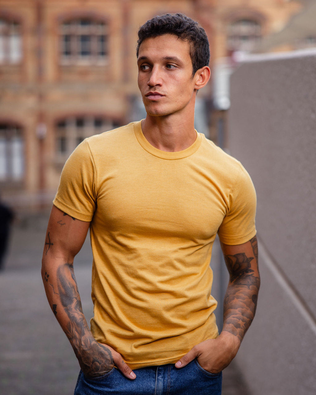 Male model wearing heather mustard colour CVC Unisex Short Sleeve Crew Neck Tee (front pose) -heather mustard