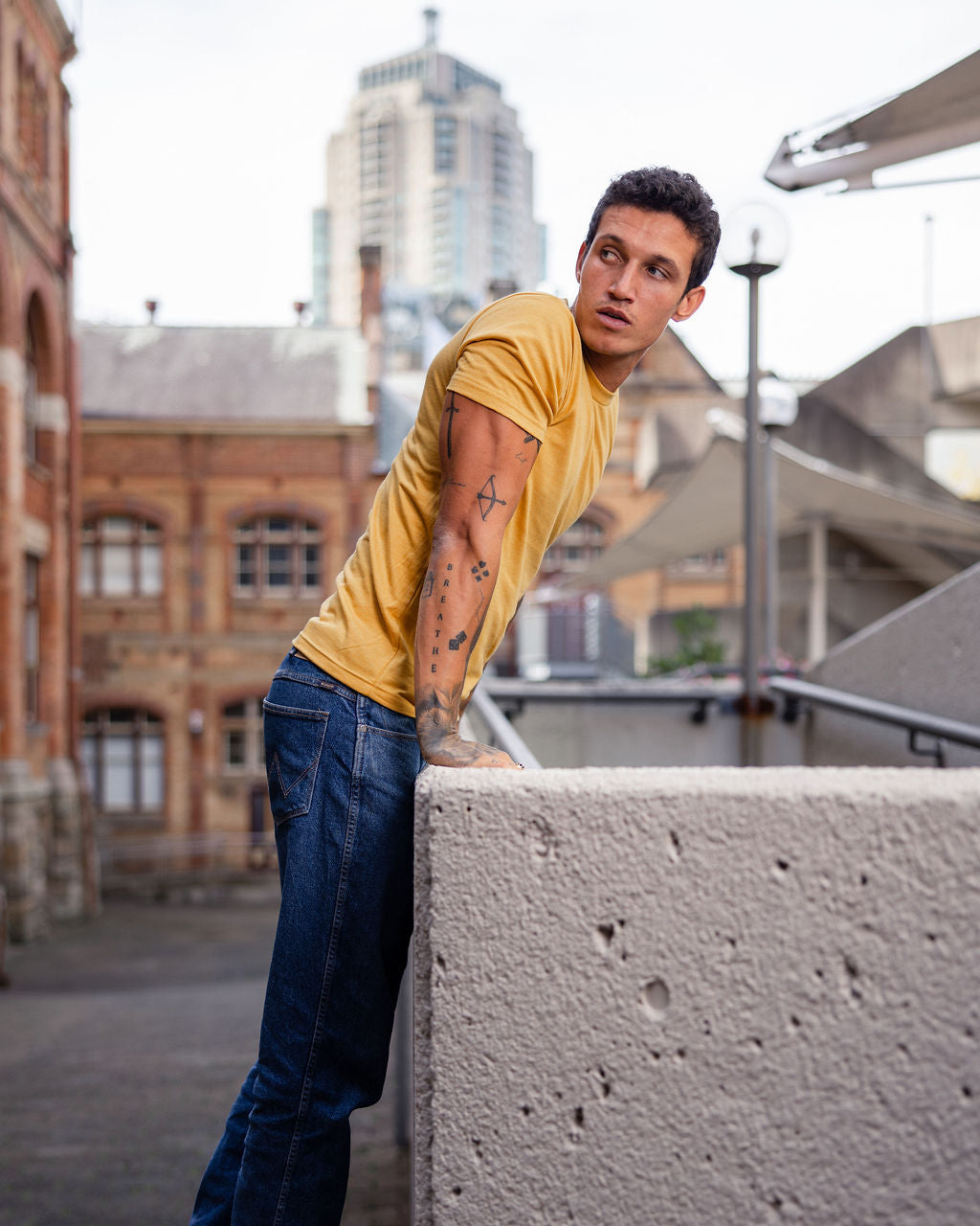 Male model wearing heather mustard colour CVC Unisex Short Sleeve Crew Neck Tee (front pose) -heather mustard