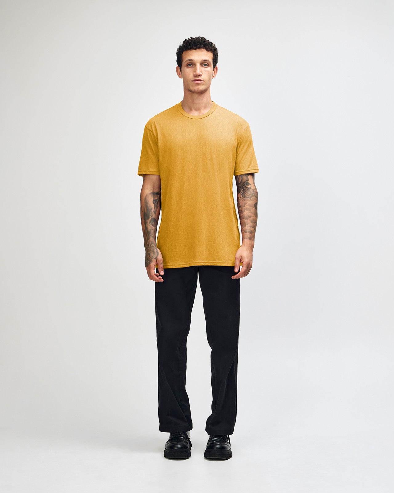 Male model wearing heather mustard colour CVC Unisex Short Sleeve Crew Neck Tee (front pose) -heather mustard