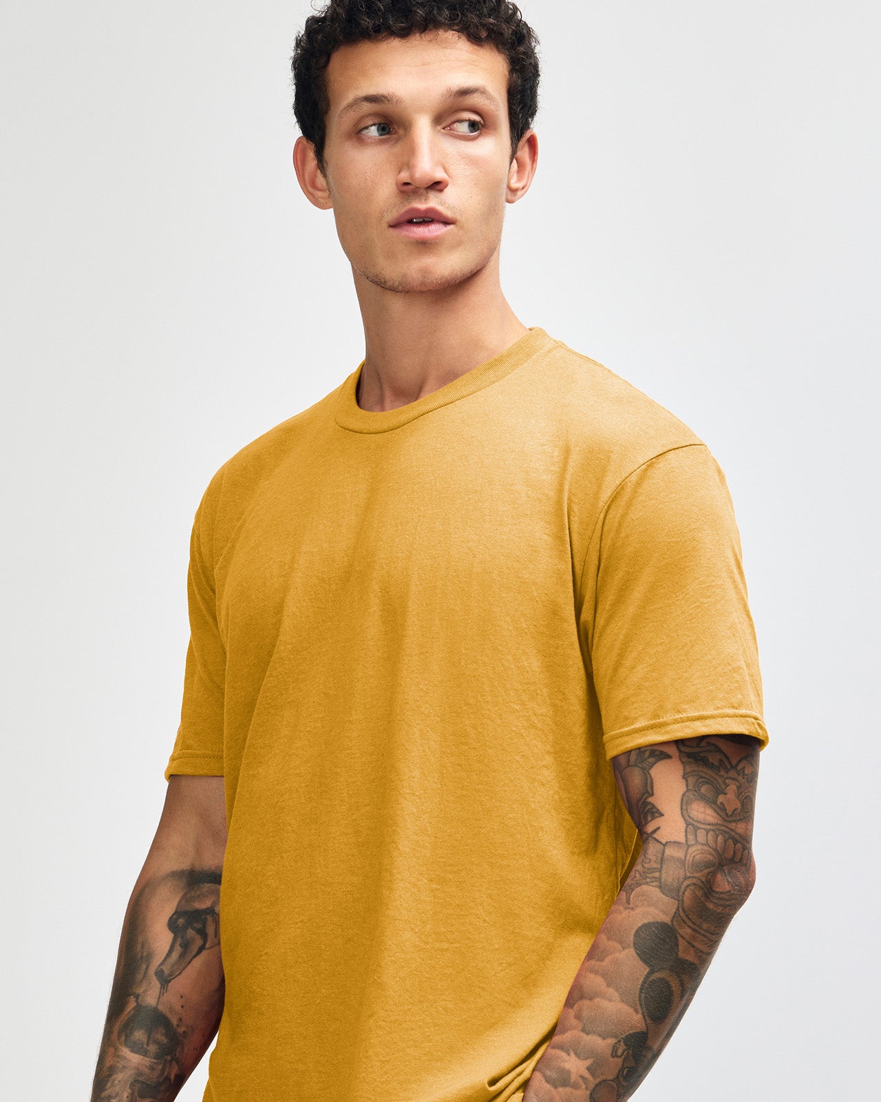 Male model wearing heather mustard colour CVC Unisex Short Sleeve Crew Neck Tee (front pose) -heather mustard