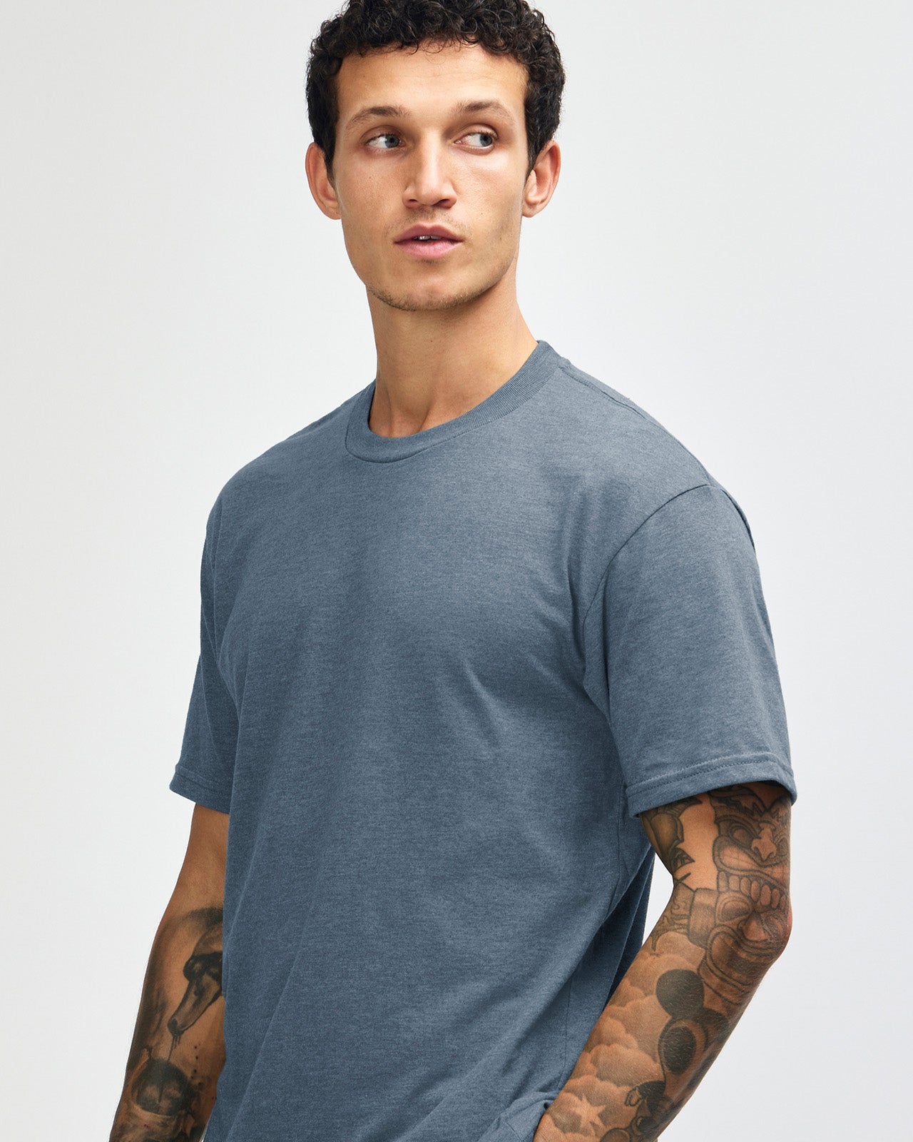 Male model wearing heather navy colour CVC Unisex Short Sleeve Crew Neck Tee (front pose) -heather navy