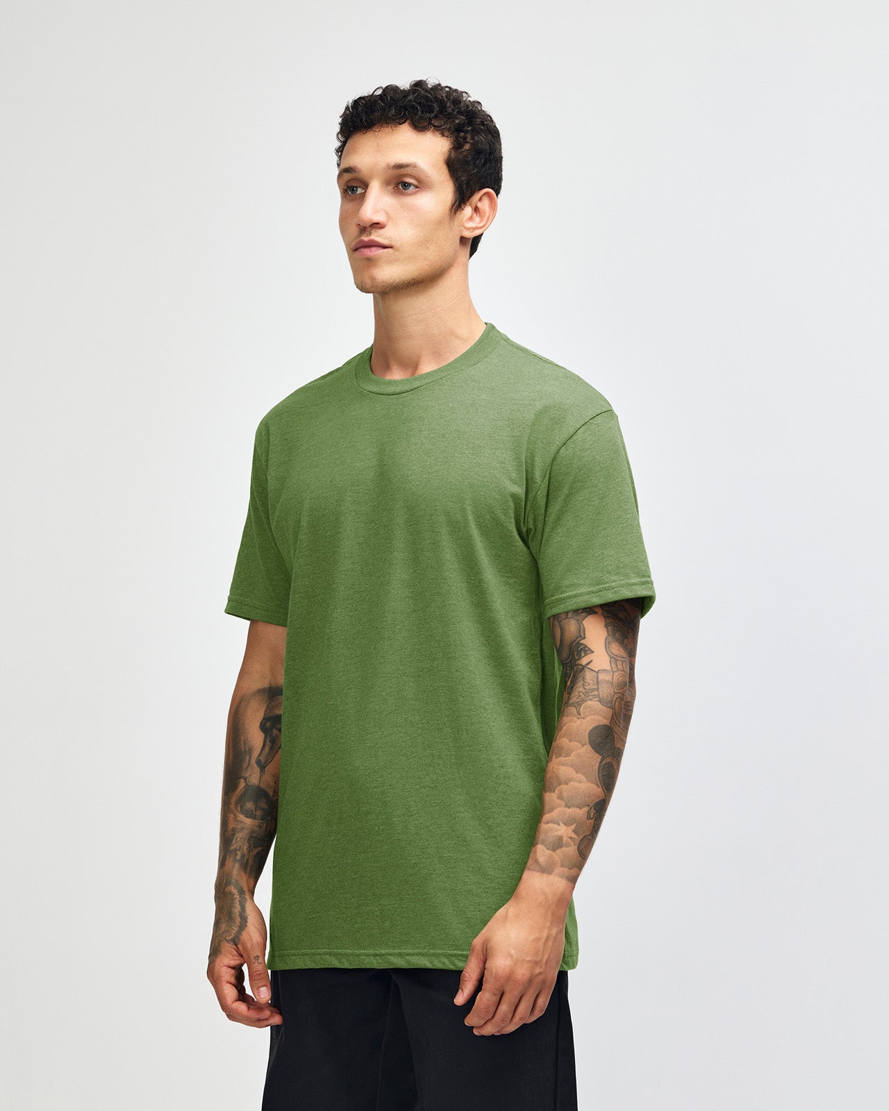 Male model wearing heather Nephrite colour CVC Unisex Short Sleeve Crew Neck Tee (front pose) -heather nephrite