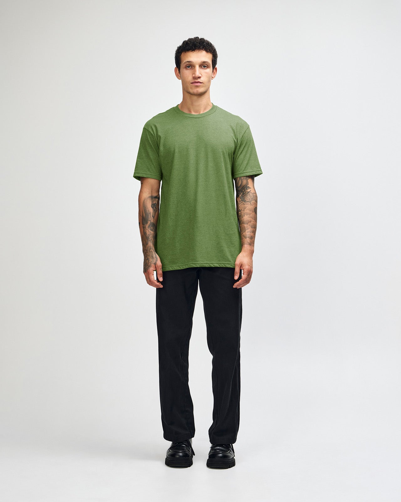 Male model wearing heather Nephrite colour CVC Unisex Short Sleeve Crew Neck Tee (front pose) -heather nephrite