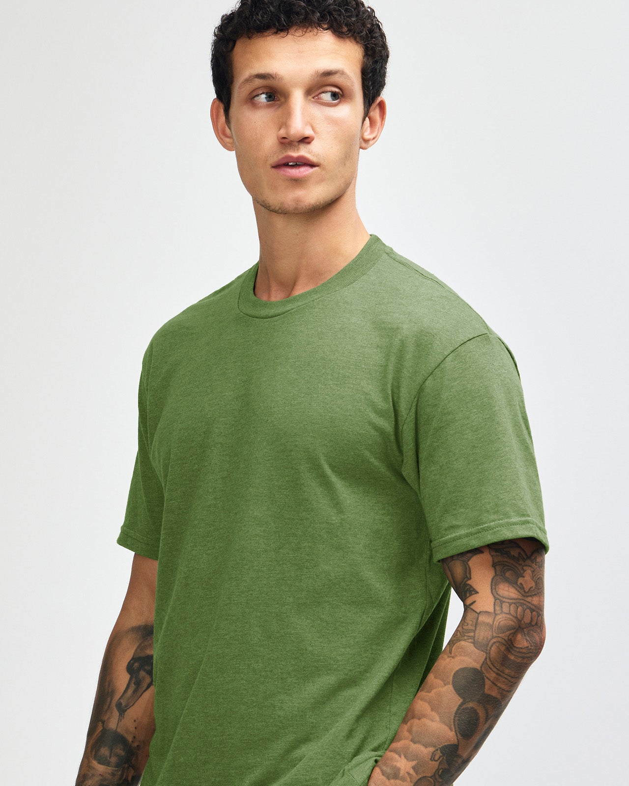 Male model wearing heather Nephrite colour CVC Unisex Short Sleeve Crew Neck Tee (front pose) -heather nephrite