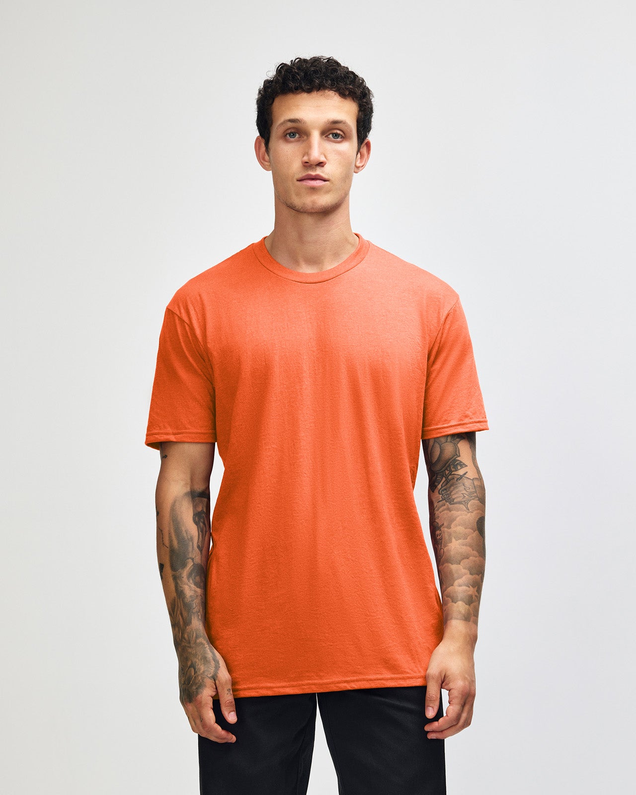 Male model wearing heather orange colour CVC Unisex Short Sleeve Crew Neck Tee (front pose) -heather orange