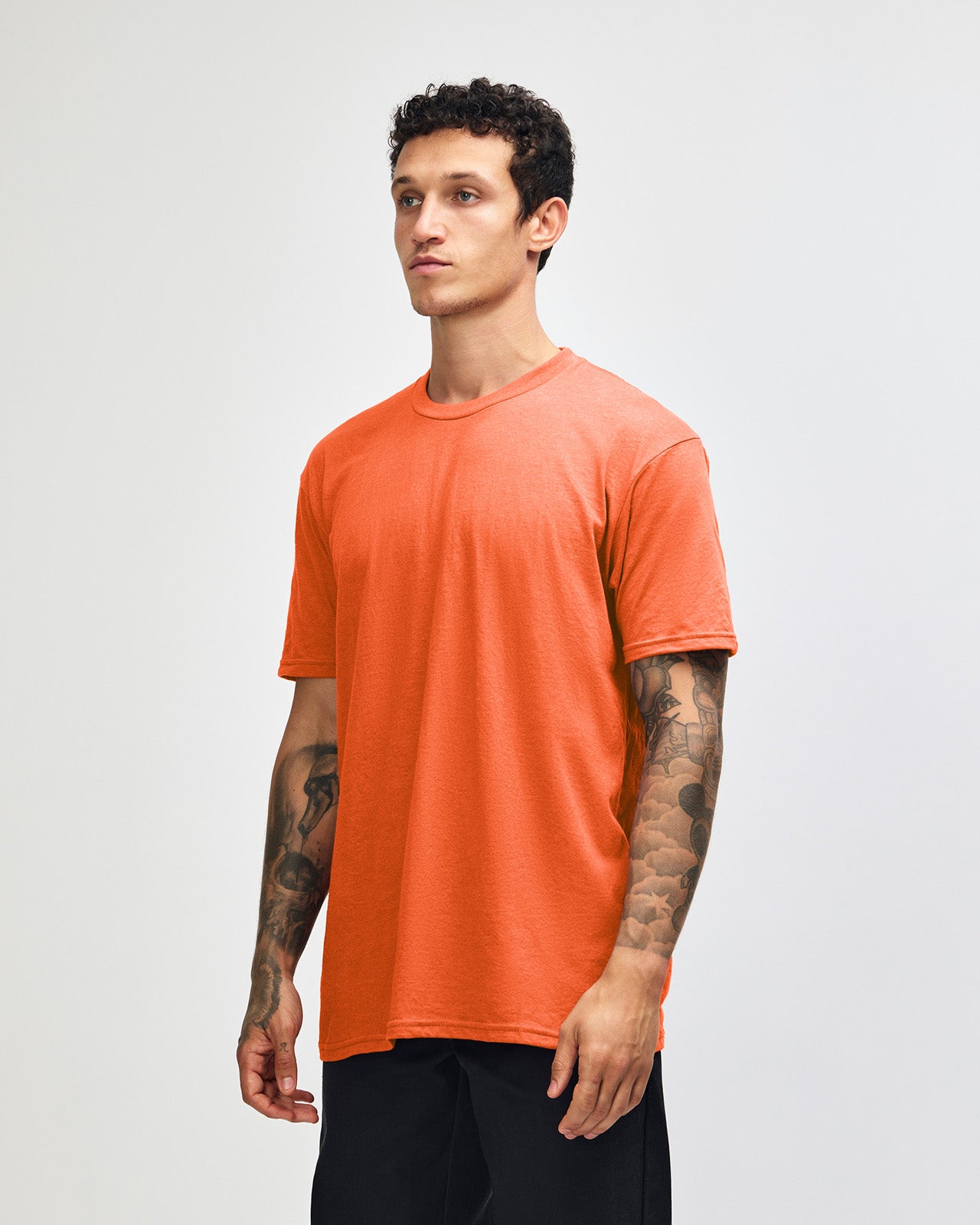 Male model wearing heather orange colour CVC Unisex Short Sleeve Crew Neck Tee (front pose) -heather orange