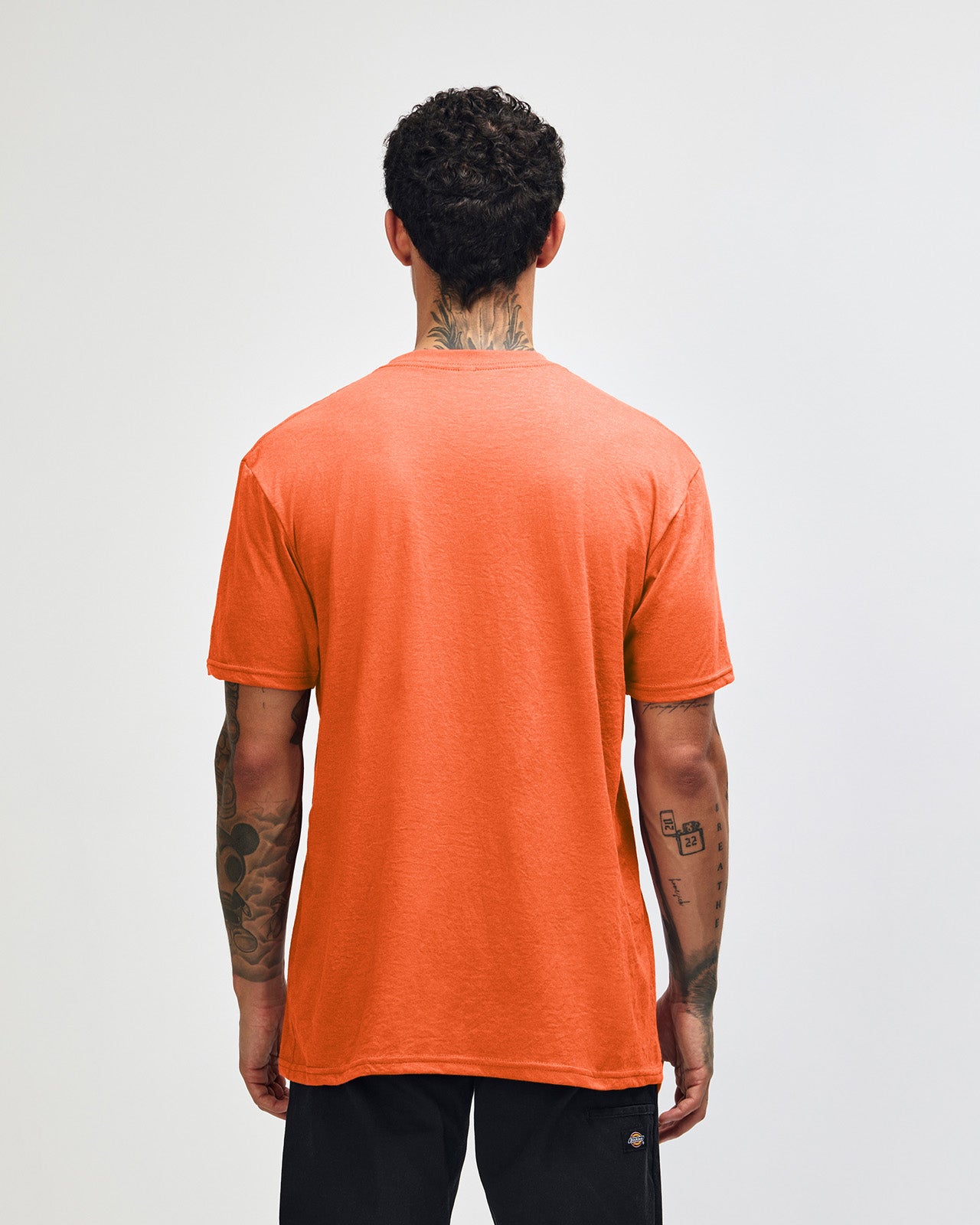Male model wearing heather orange colour CVC Unisex Short Sleeve Crew Neck Tee (back pose) -heather orange