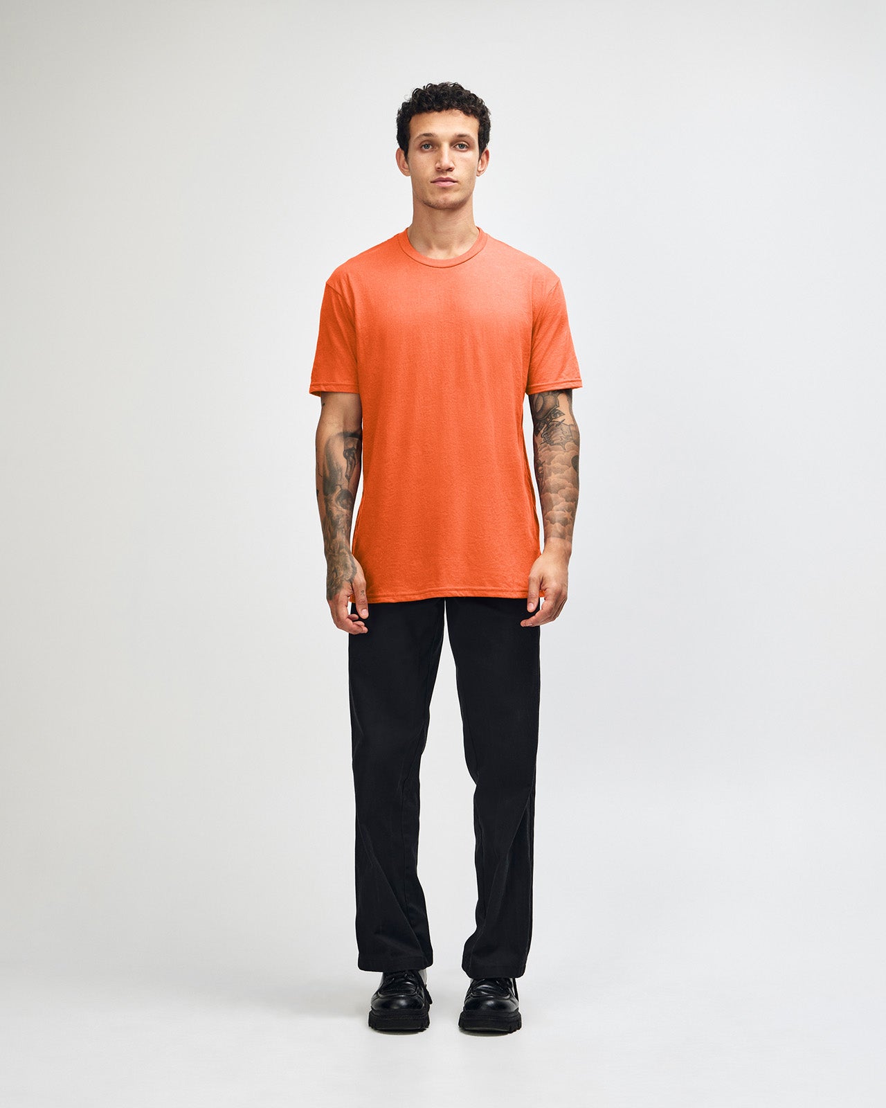 Male model wearing heather orange colour CVC Unisex Short Sleeve Crew Neck Tee (front pose) -heather orange