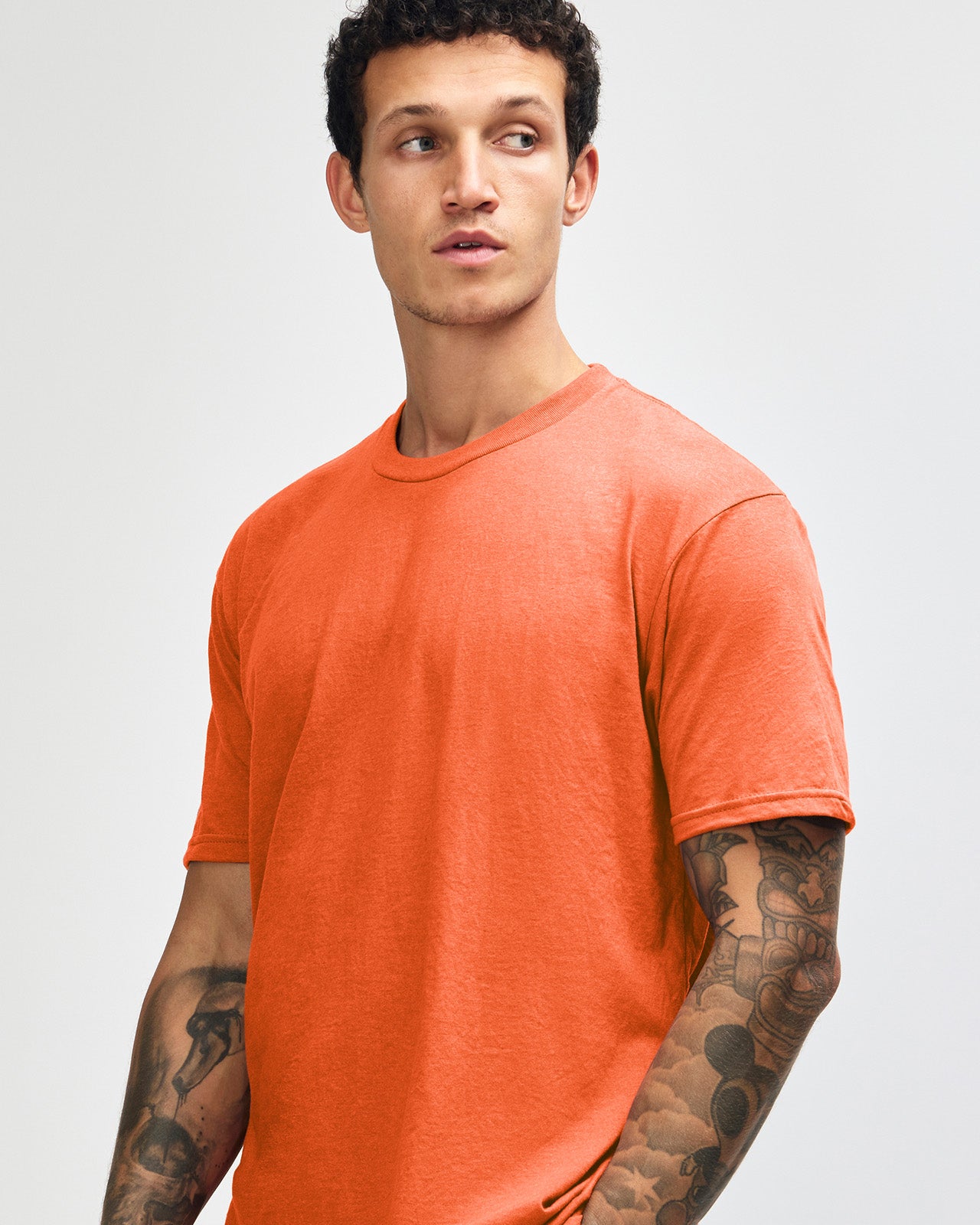 Male model wearing heather orange colour CVC Unisex Short Sleeve Crew Neck Tee (front pose) -heather orange