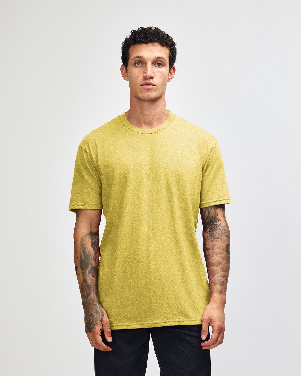 Male model wearing heather pannacotta colour CVC Unisex Short Sleeve Crew Neck Tee (front pose) -heather pannacotta