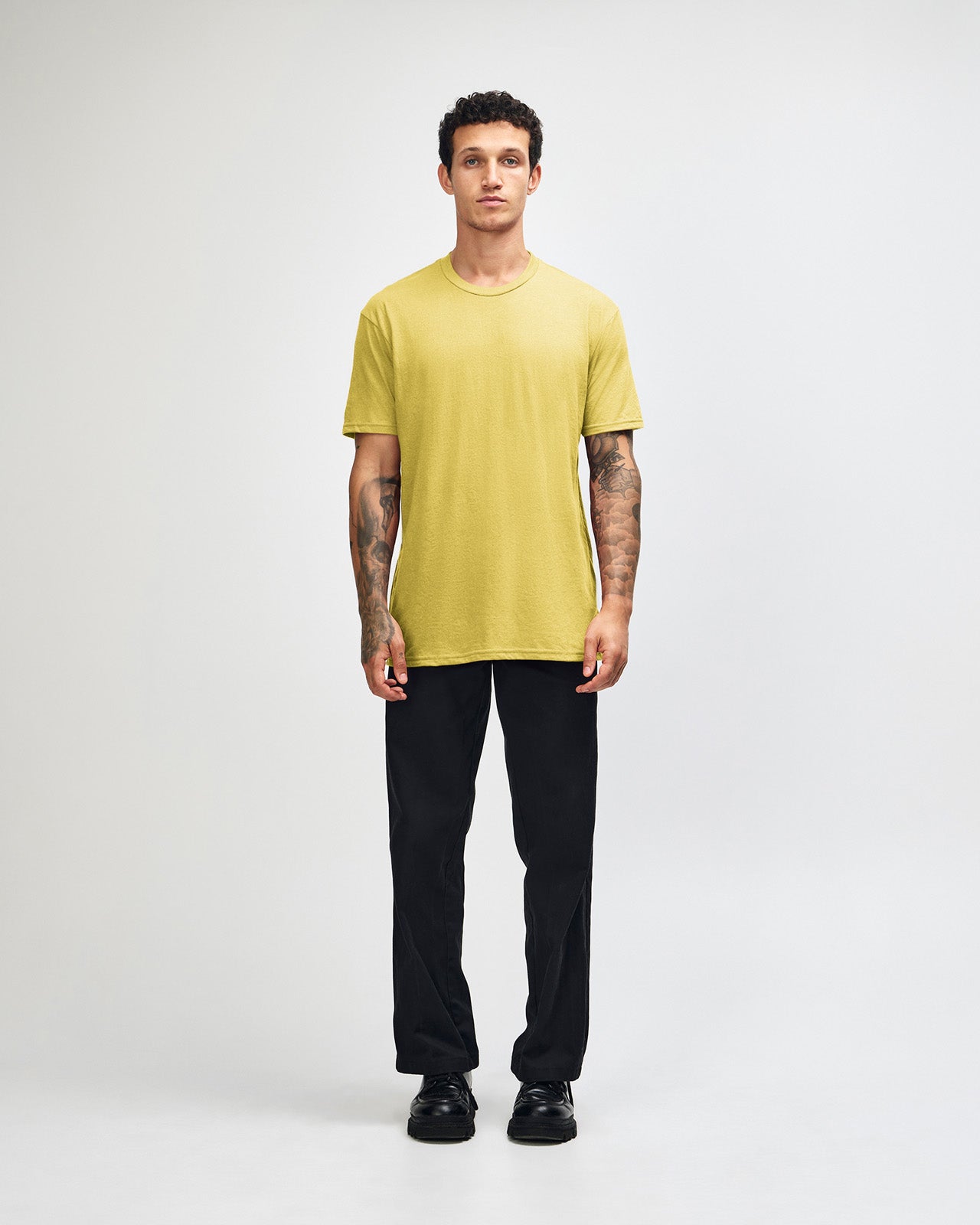 Male model wearing heather pannacotta colour CVC Unisex Short Sleeve Crew Neck Tee (front pose) -heather pannacotta