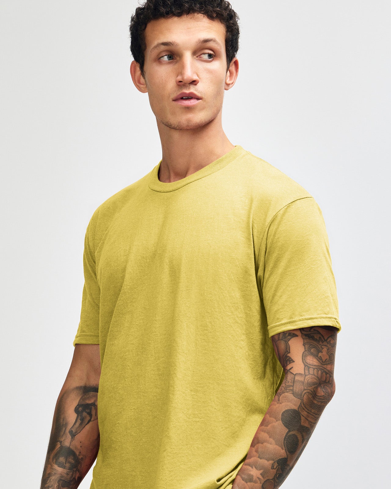 Male model wearing heather pannacotta colour CVC Unisex Short Sleeve Crew Neck Tee (front pose) -heather pannacotta