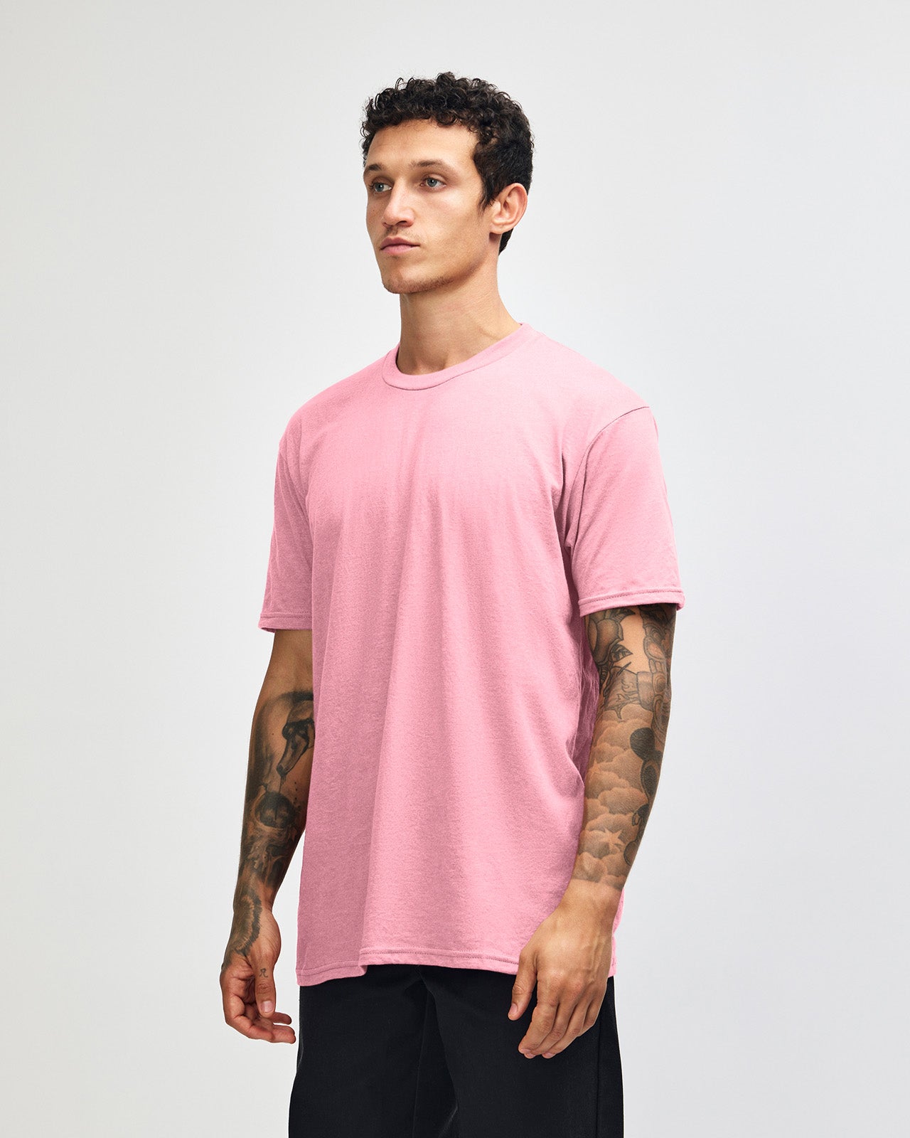Male model wearing heather pink colour CVC Unisex Short Sleeve Crew Neck Tee (side pose) -heather pink