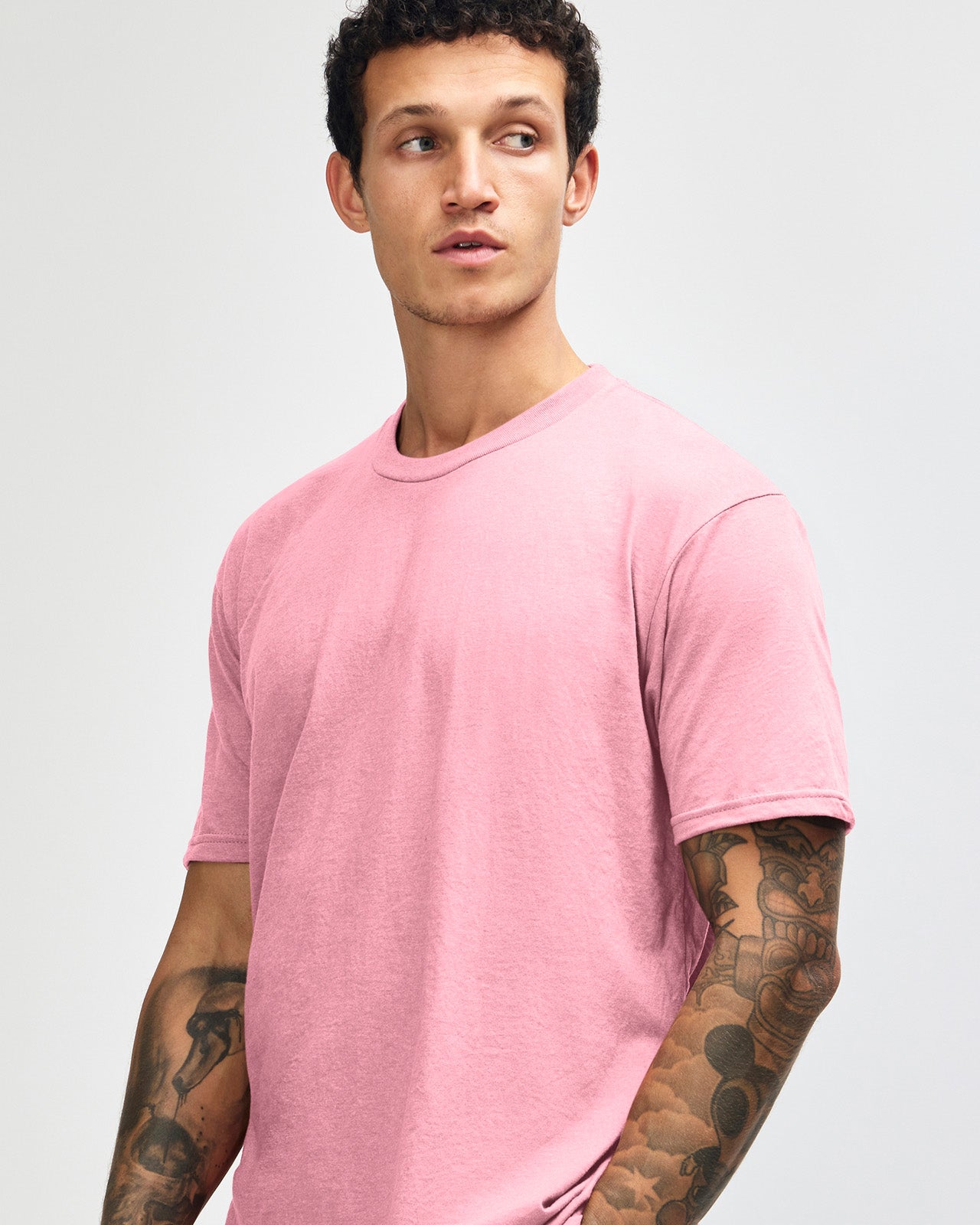 Male model wearing heather pink colour CVC Unisex Short Sleeve Crew Neck Tee (front pose) -heather pink