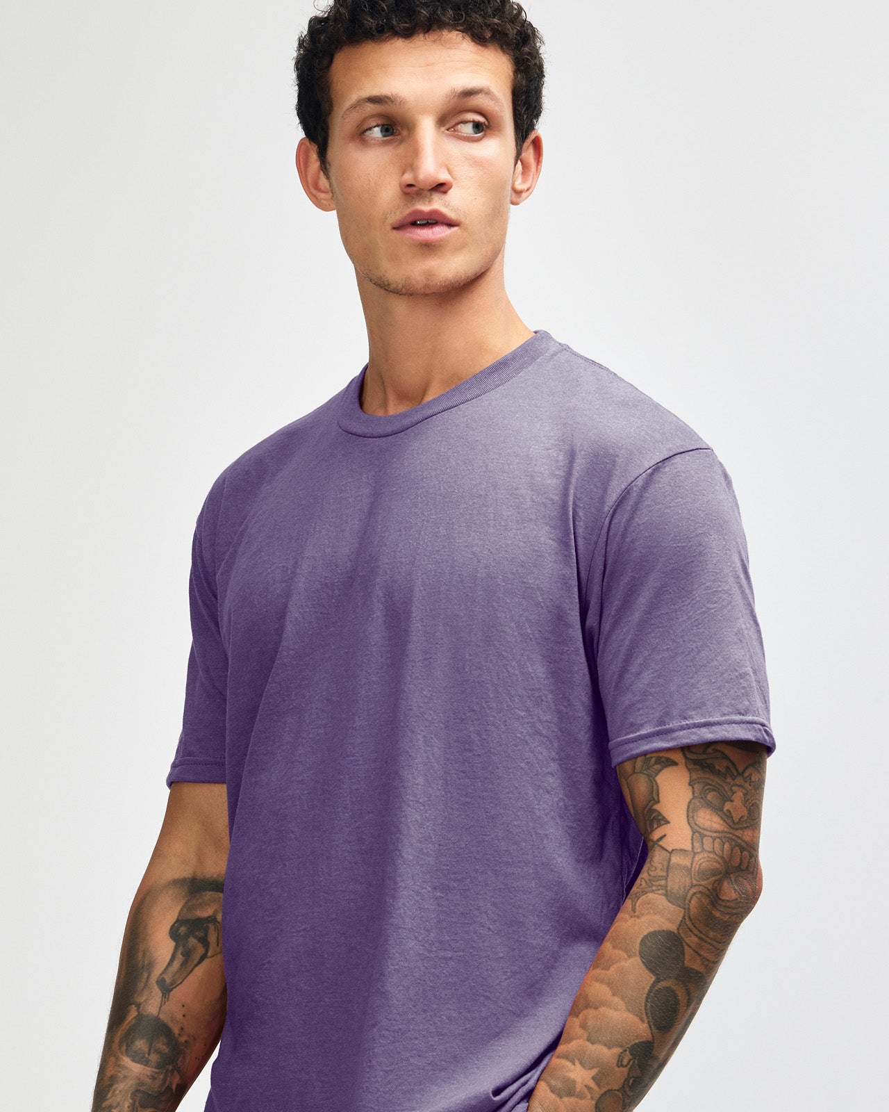 Male model wearing heather purple colour CVC Unisex Short Sleeve Crew Neck Tee (front pose) -heather purple