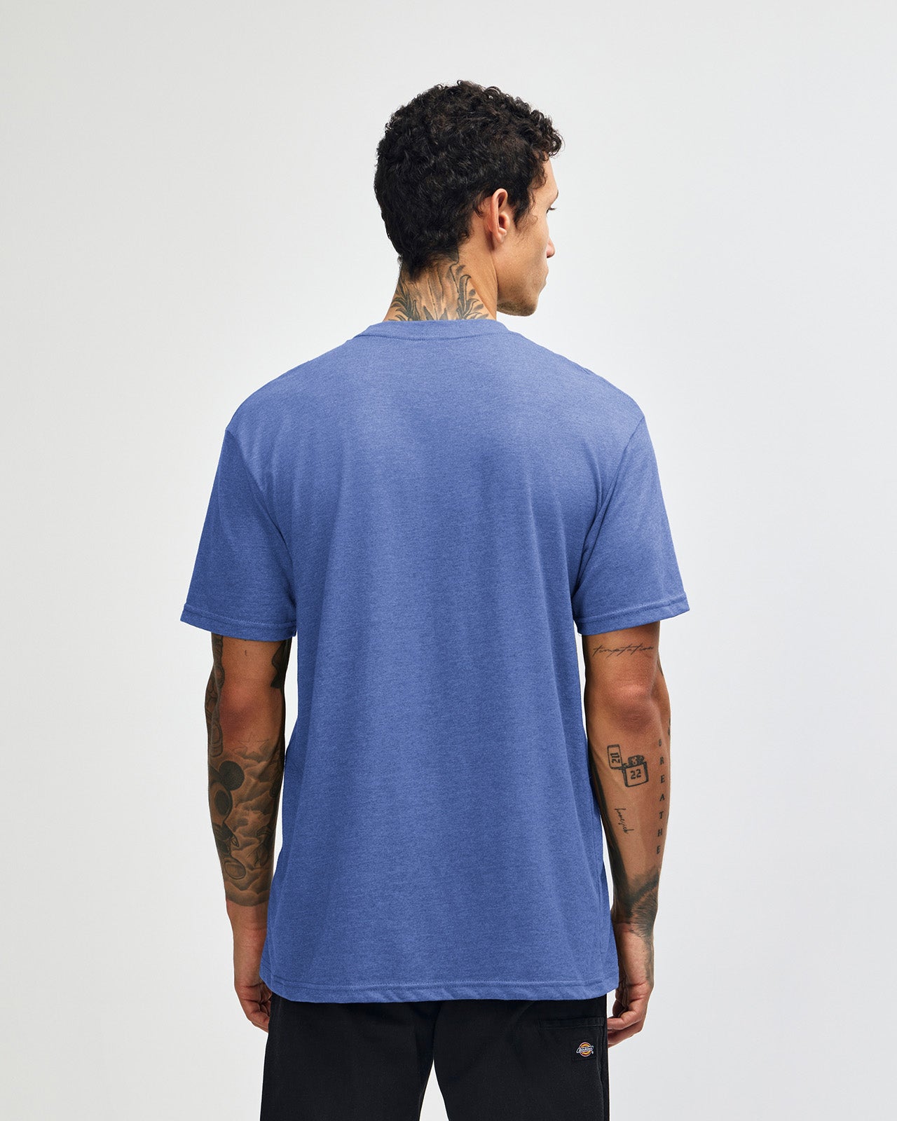 Male model wearing heather Royal Blue colour CVC Unisex Short Sleeve Crew Neck Tee (back pose) -heather royal blue