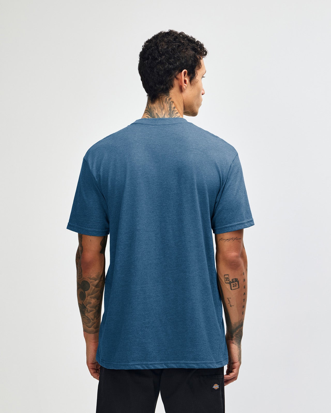 Male model wearing heather sea blue colour CVC Unisex Short Sleeve Crew Neck Tee (back pose) -heather sea blue